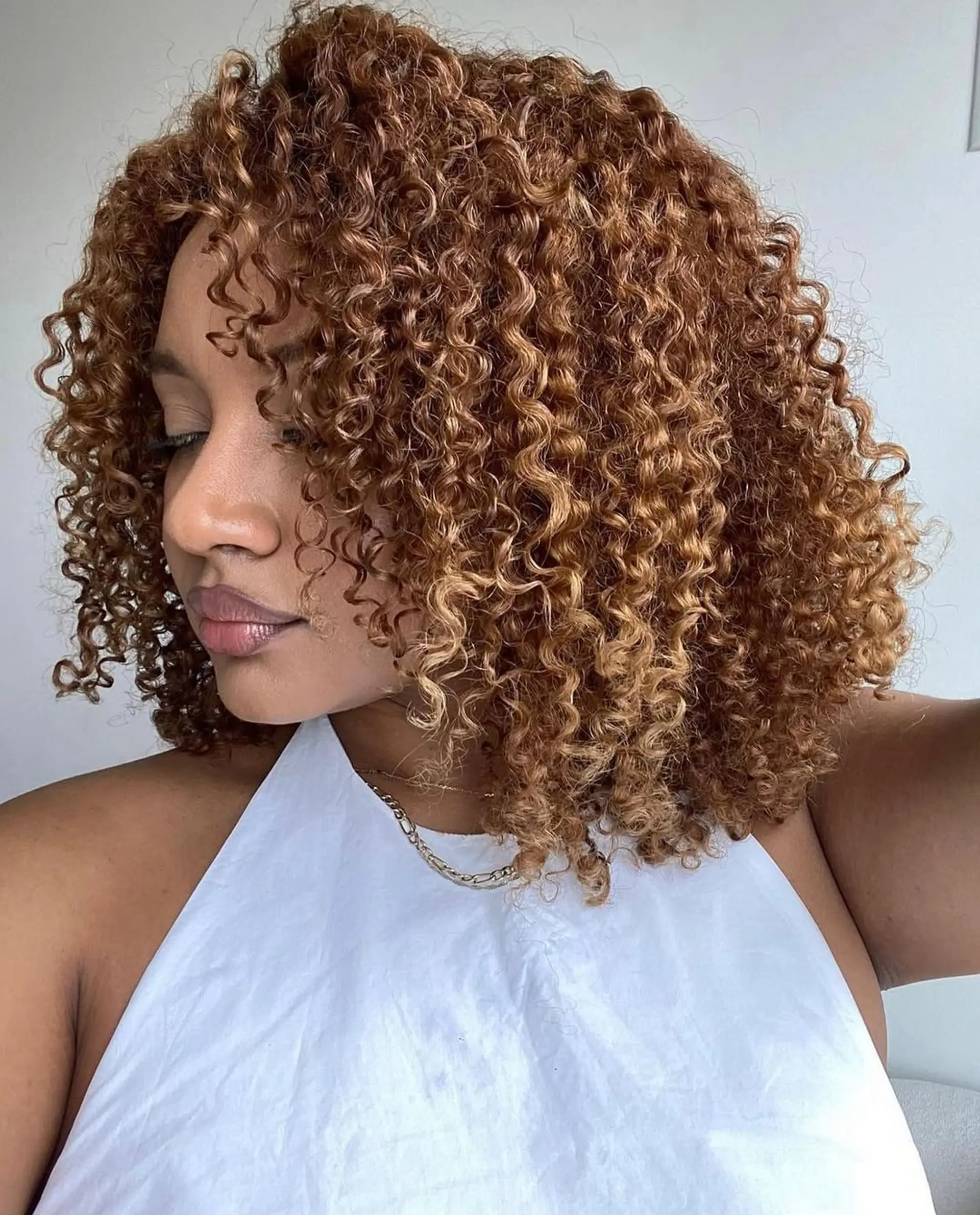 A shoulder-length curly bob hairstyle with defined curls and a beautiful shape. 1