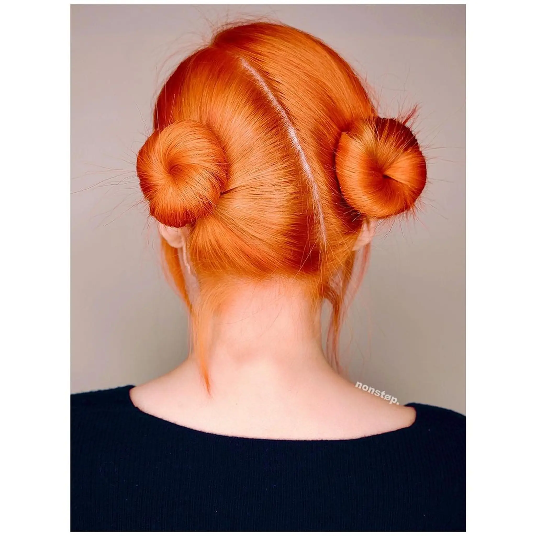 Two symmetrical, tight buns with a middle part on straight, medium-length, red-orange hair. (NonstopStyle: by Vincent) 1