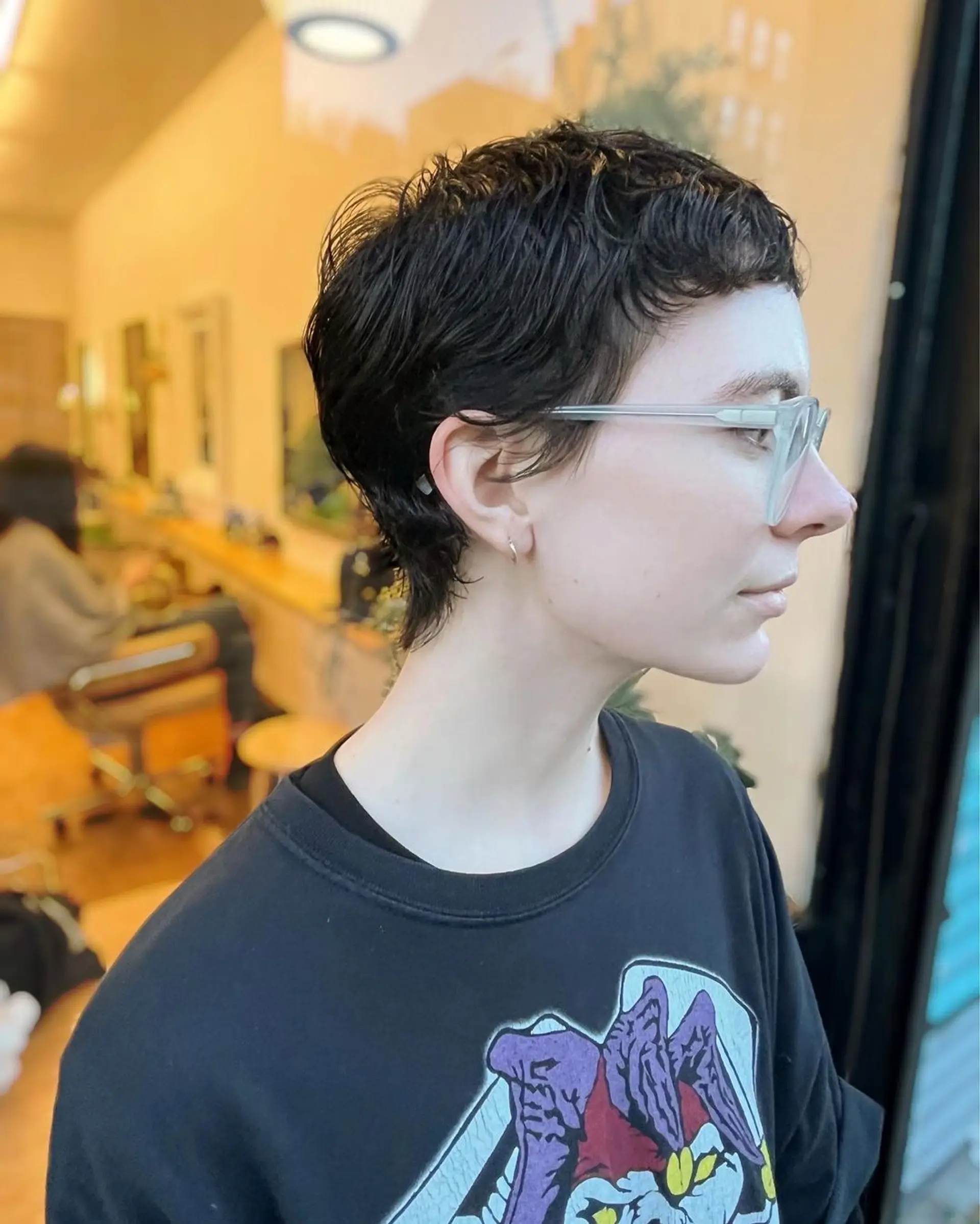 A chic short hairstyle with subtle waves in dark brown, giving it an effortlessly stylish, contemporary look. 1