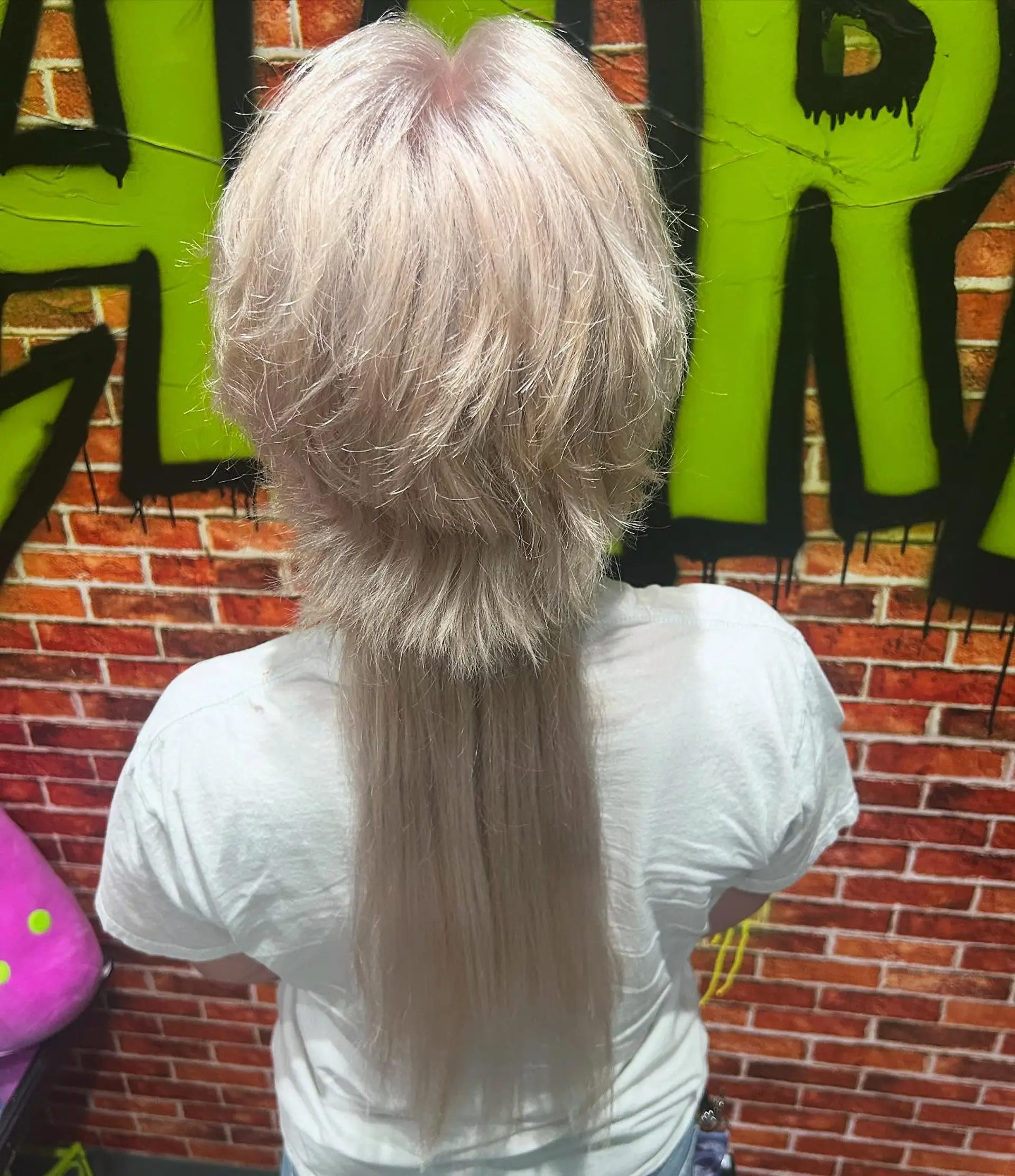 A textured platinum blonde anime-inspired mullet featuring heavily layered, voluminous crown sections that contrast with a long, straight rat tail down the back. 1