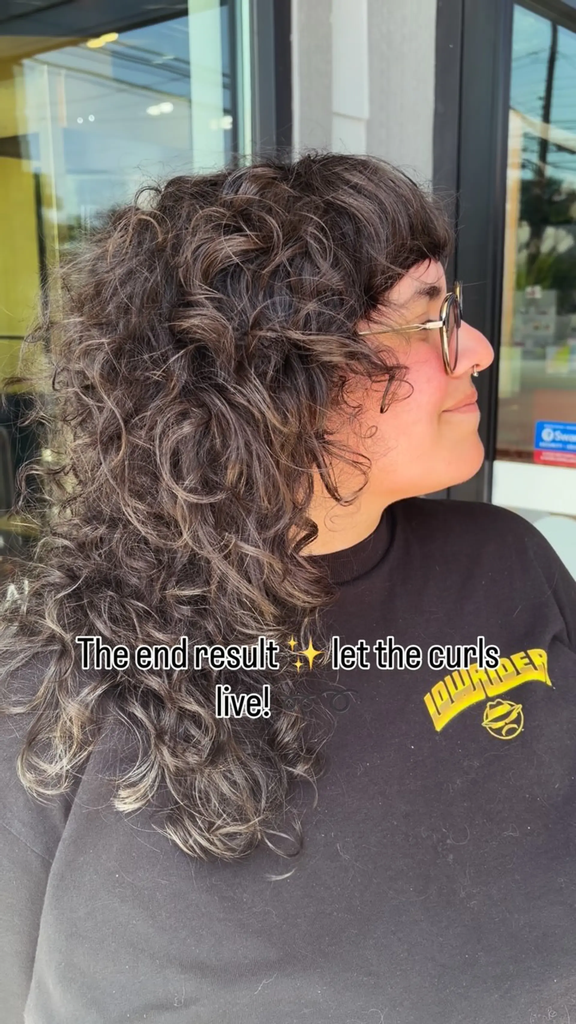 A layered curly shag cut with textured volume and brow-skimming bangs framing the face. 1