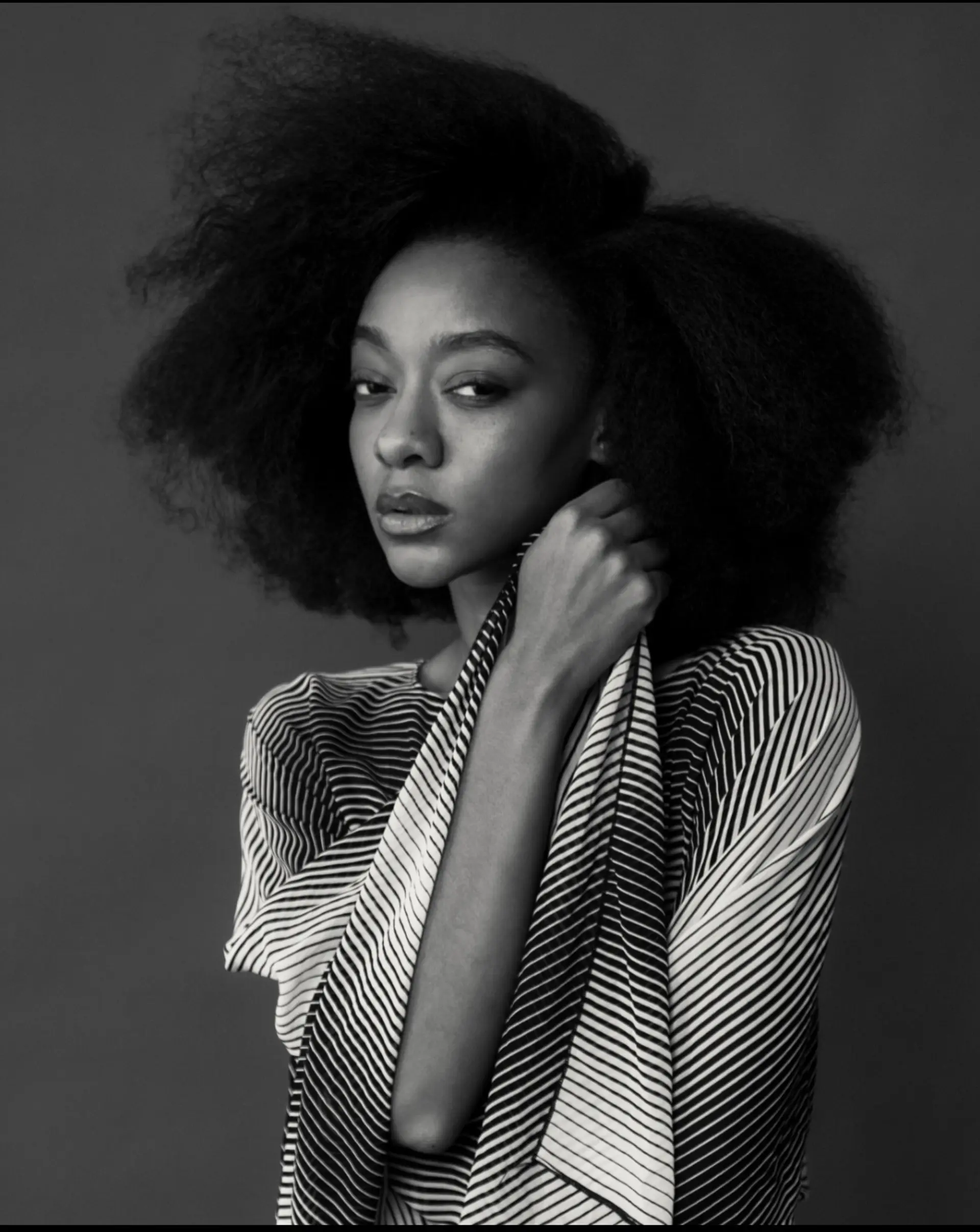 A dramatic, voluminous afro hairstyle with soft, cloud-like texture and an expansive silhouette. 1