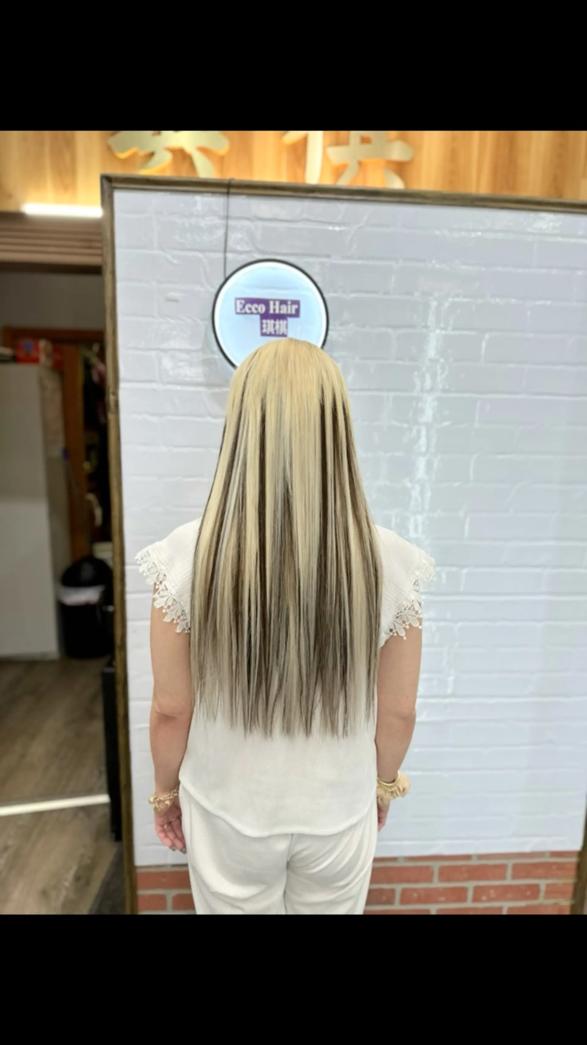 Long, sleek straight hair styled with bold, high-contrast blonde and dark brown chunky streaks. 1