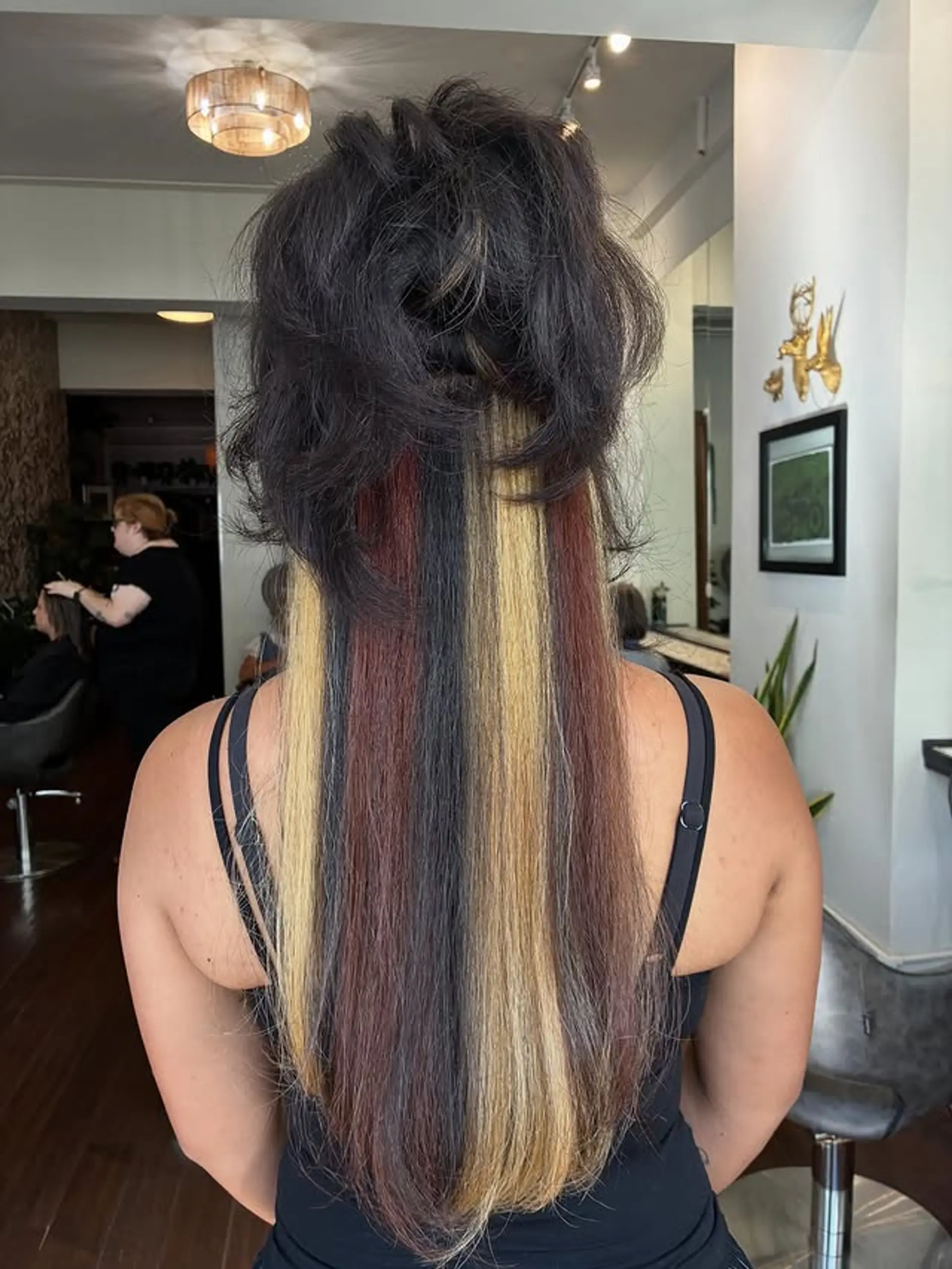 A layered long hairstyle with bold, chunky highlights. 1