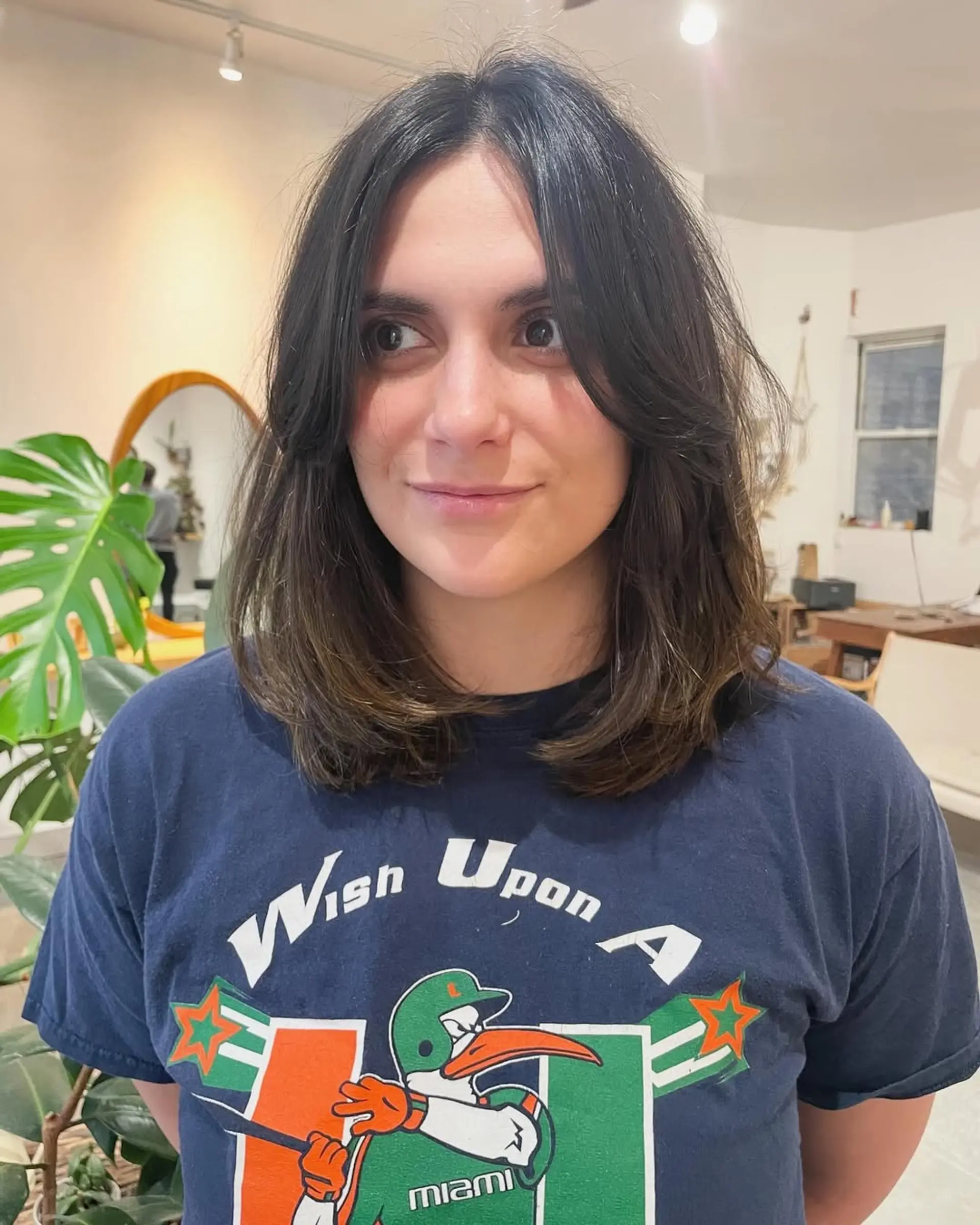 A trendy layered haircut featuring curtain bangs and face-framing layers. 1