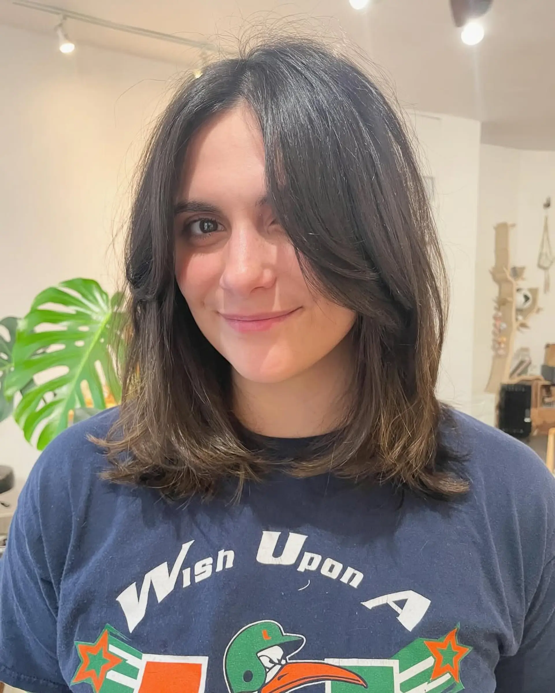 A trendy layered haircut featuring curtain bangs and face-framing layers. 2