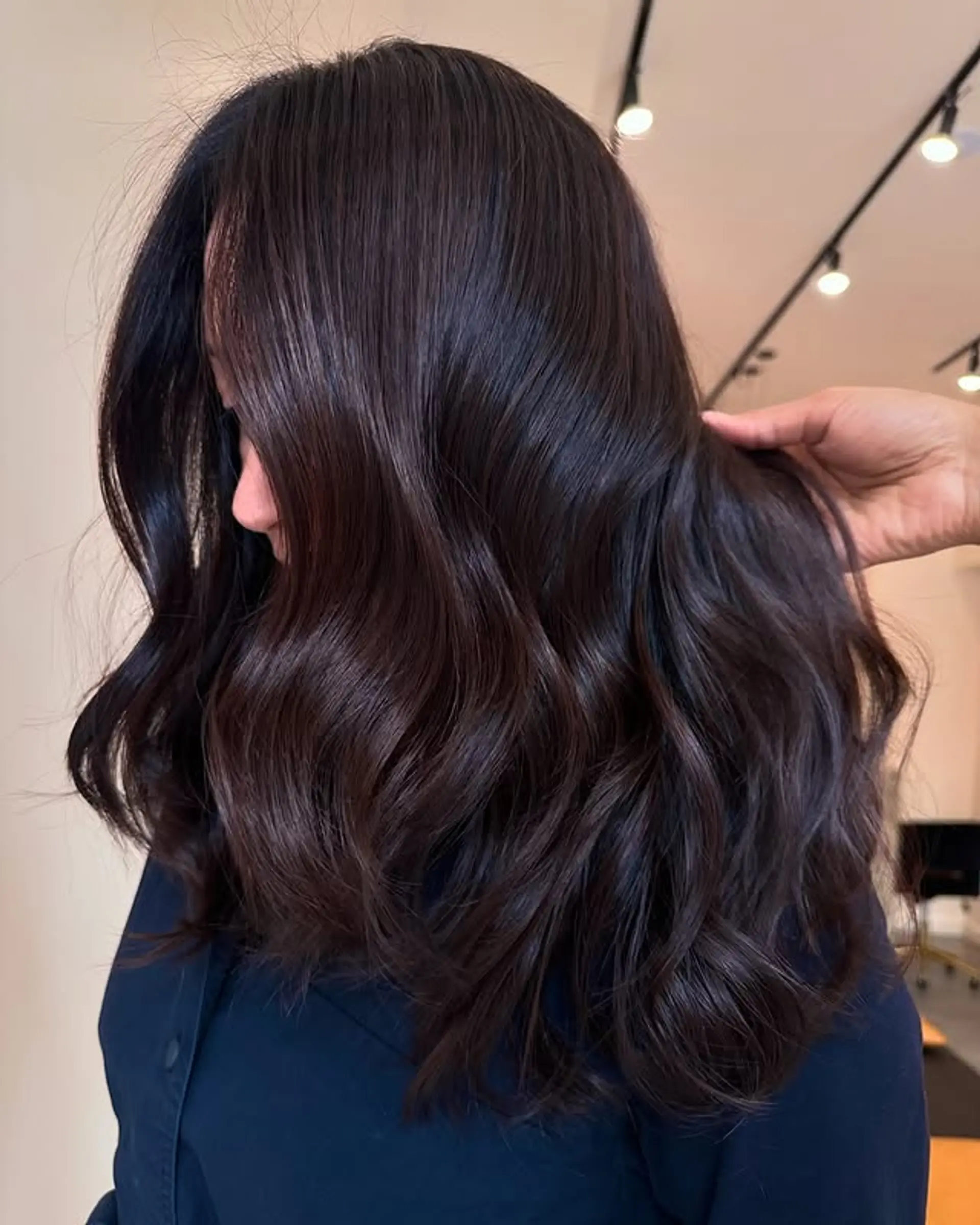 Long, layered hairstyle with soft, glossy waves. 1