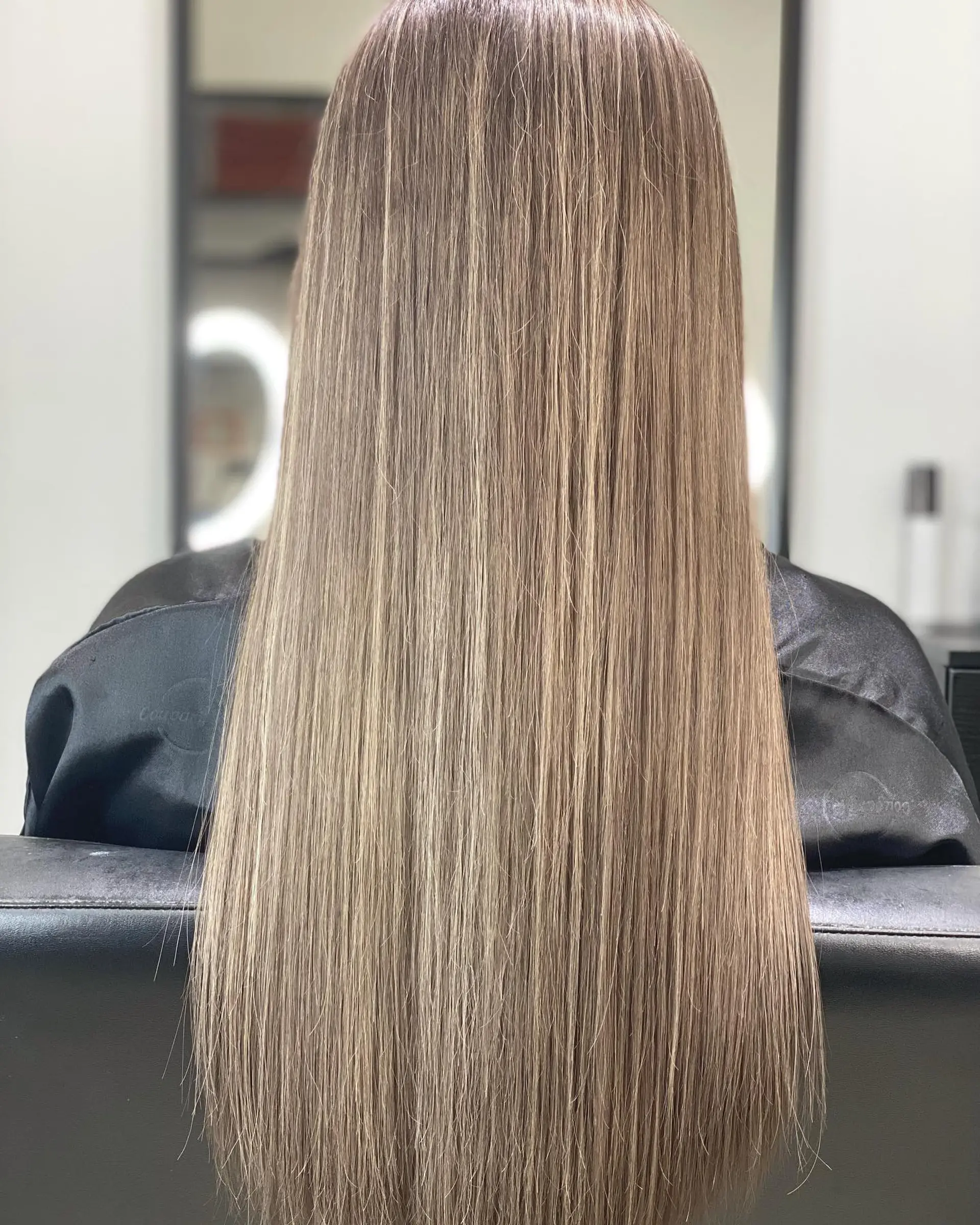 Very long silky straight hair with a beautiful ash blonde balayage. 1