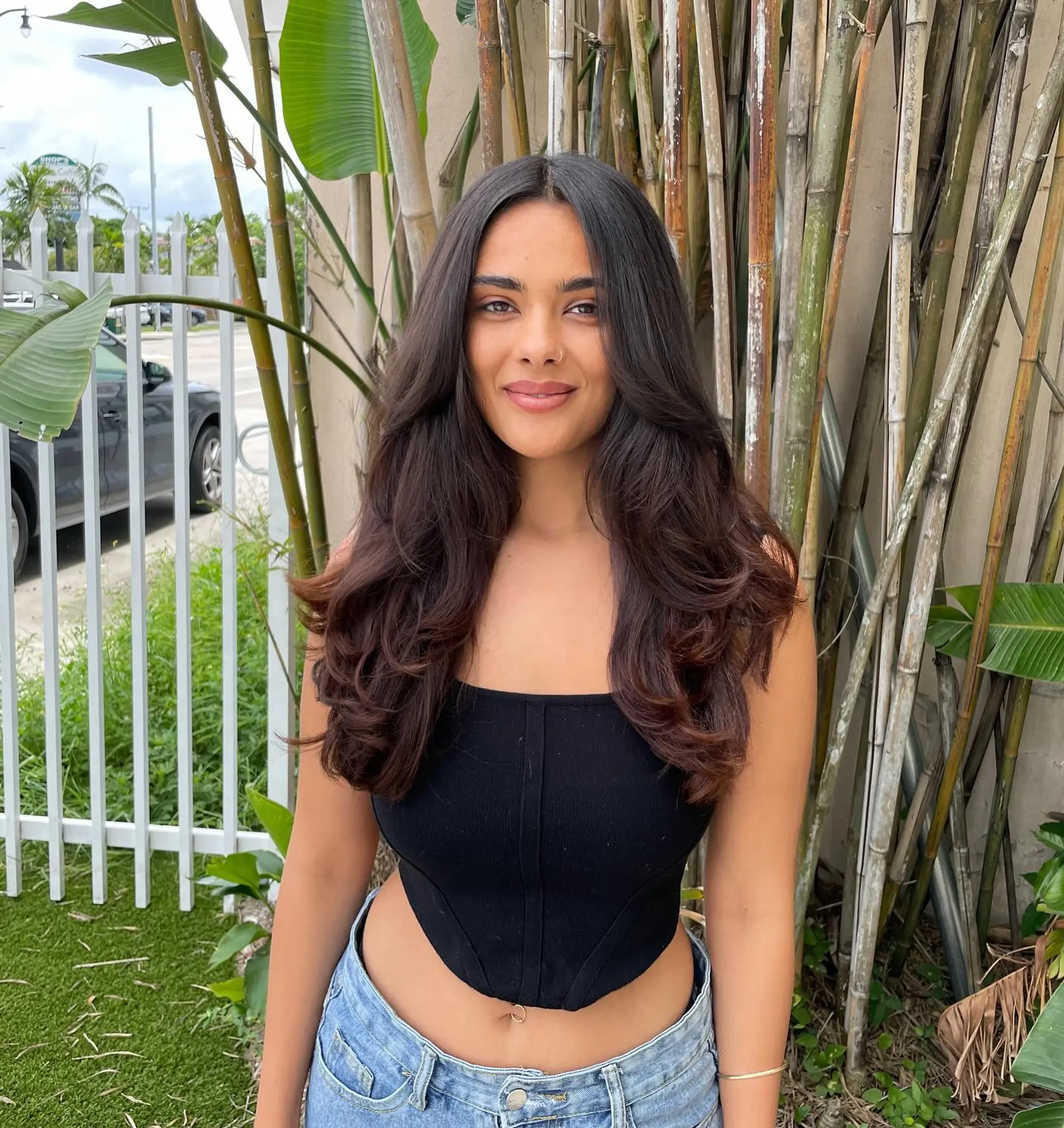 Long, wavy hairstyle with layered ends and face-framing layers. 1