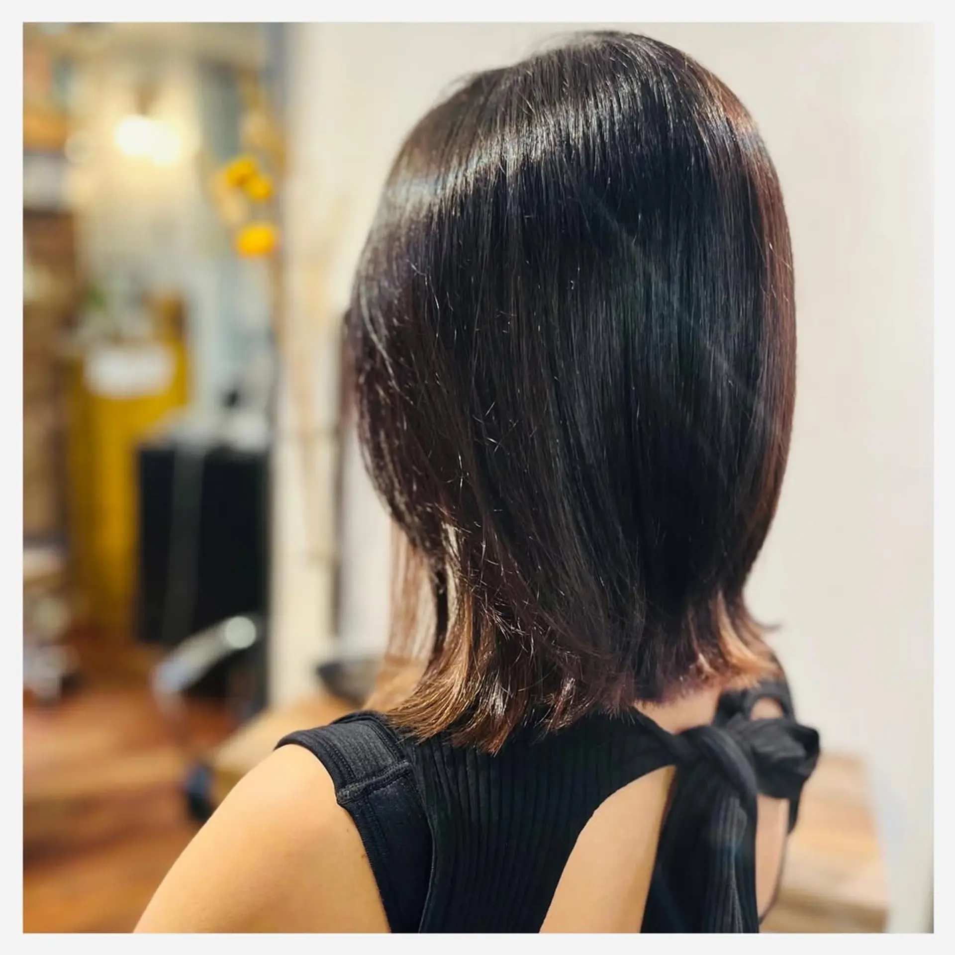 A sleek, medium-length bob hairstyle with subtle layers. 1