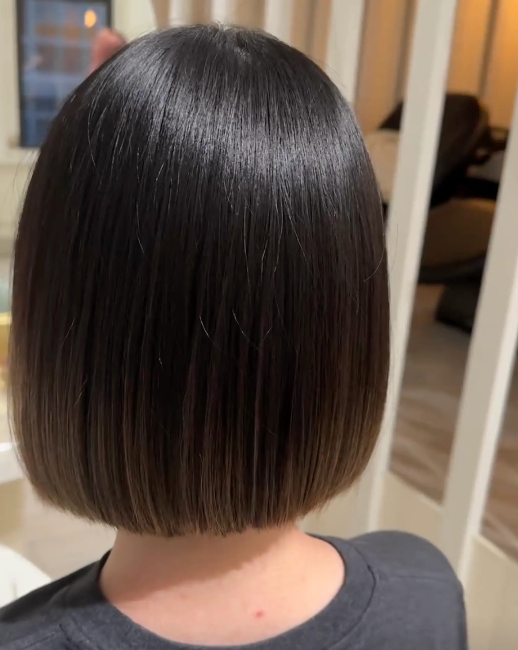 A sleek and glossy blunt cut bob with straight texture, short length, and a polished finish, perfect for a classic and sophisticated look.

 1