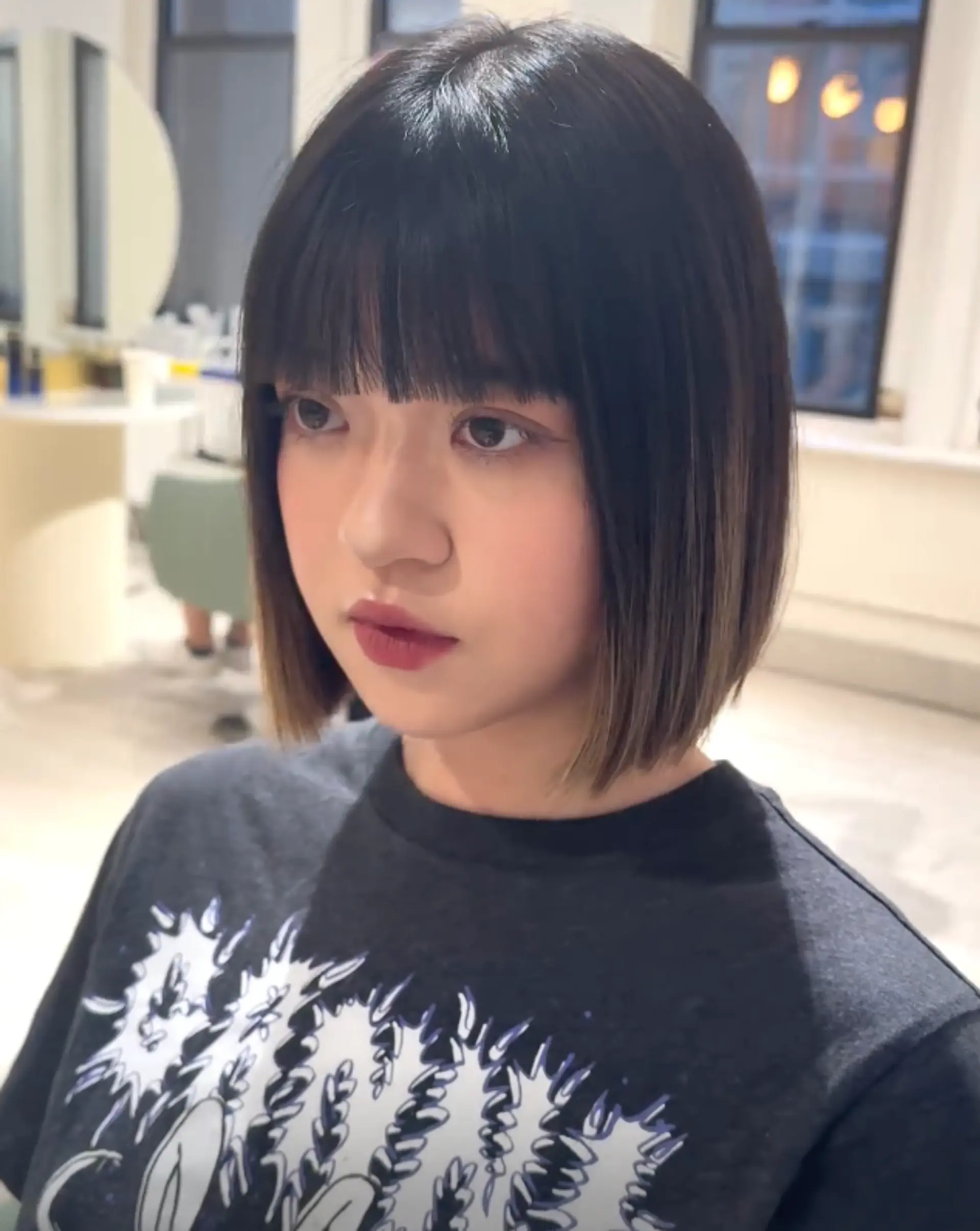 A sleek and glossy blunt cut bob with straight texture, short length, and a polished finish, perfect for a classic and sophisticated look.

 2