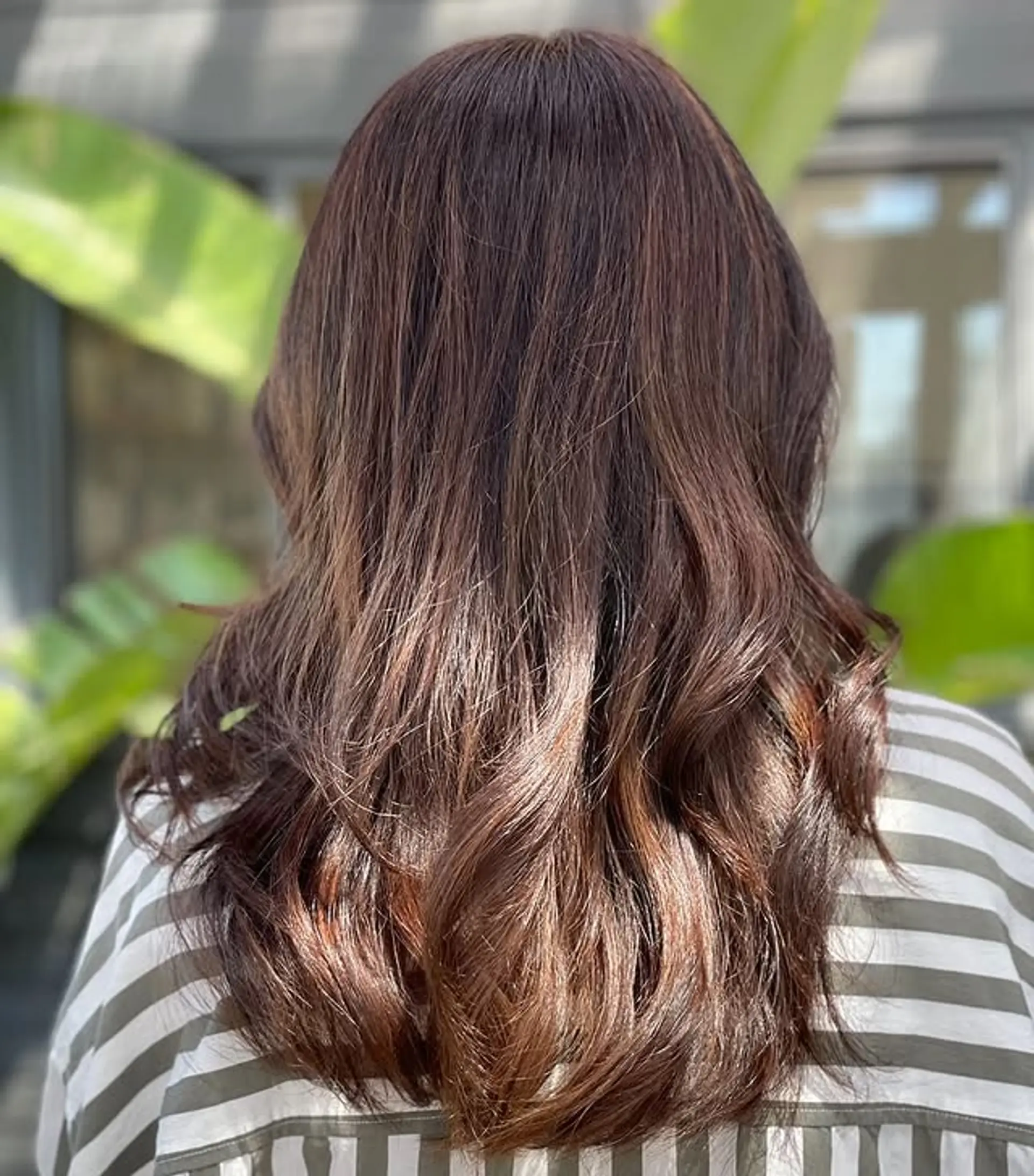 Long wavy hairstyle with a brunette to auburn balayage. 1