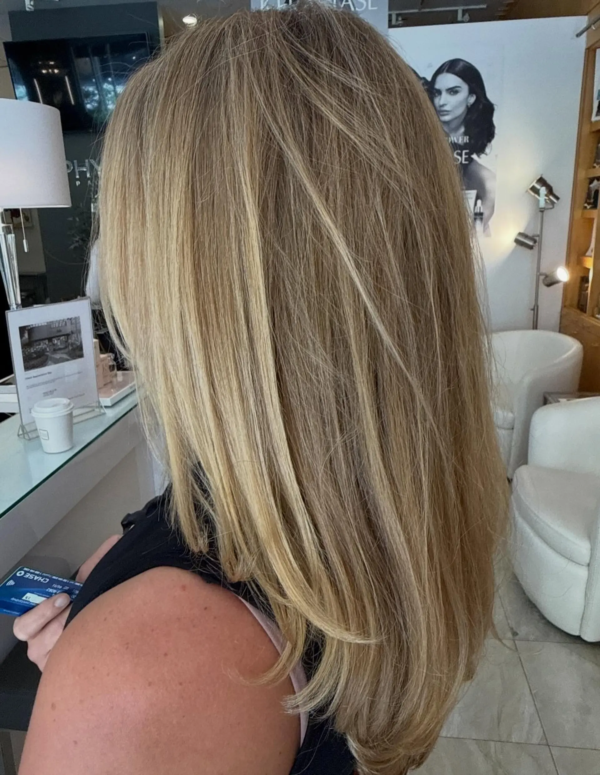 Long, smooth blonde hair with fine highlights and soft face-framing layers styled straight with a gentle bend at the ends. 1