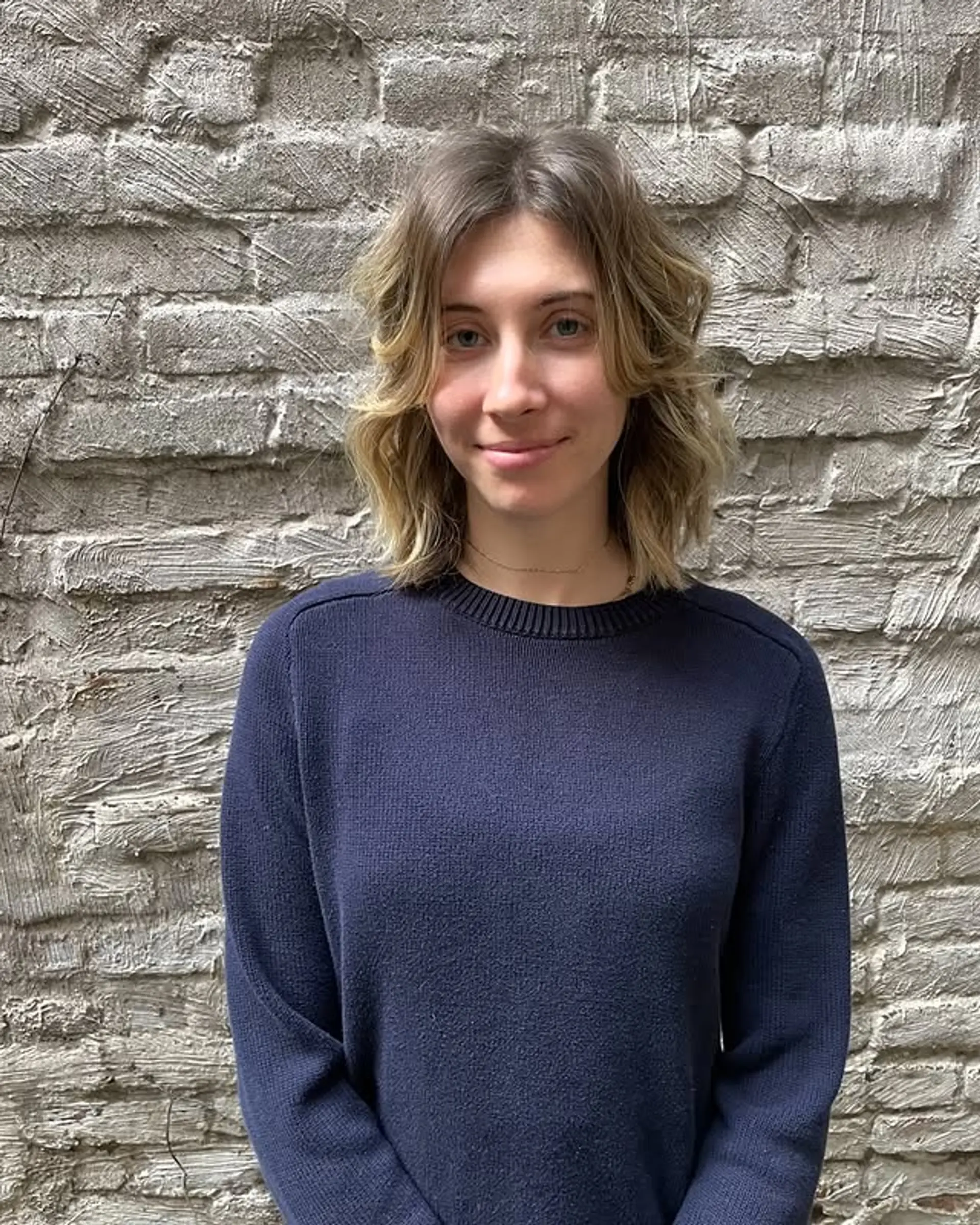 A textured shag haircut with face-framing layers and trendy curtain bangs. 1