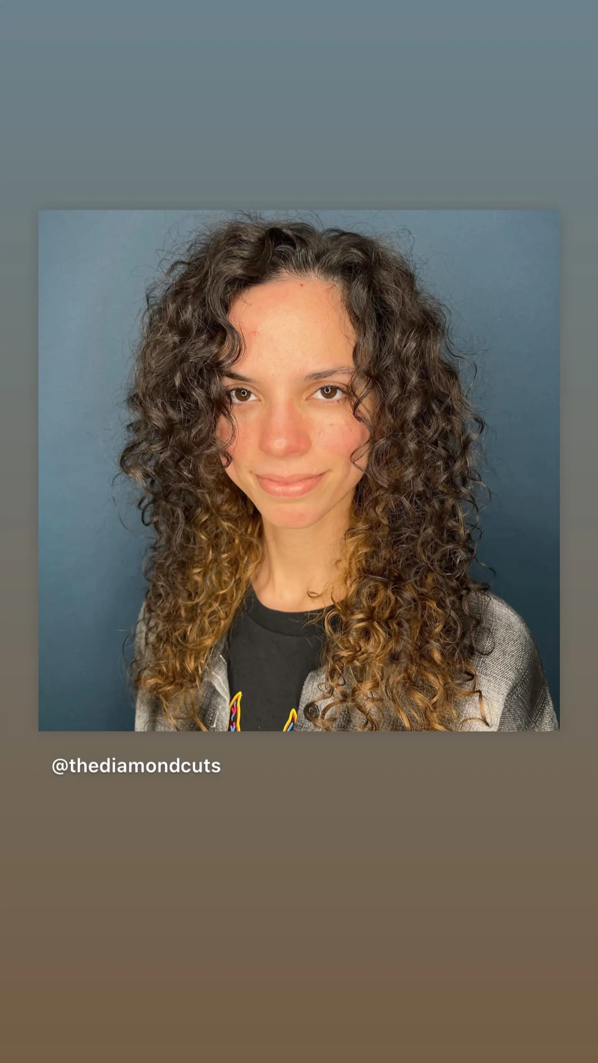 A medium-length curly hairstyle featuring a layered cut with face-framing highlights. 1