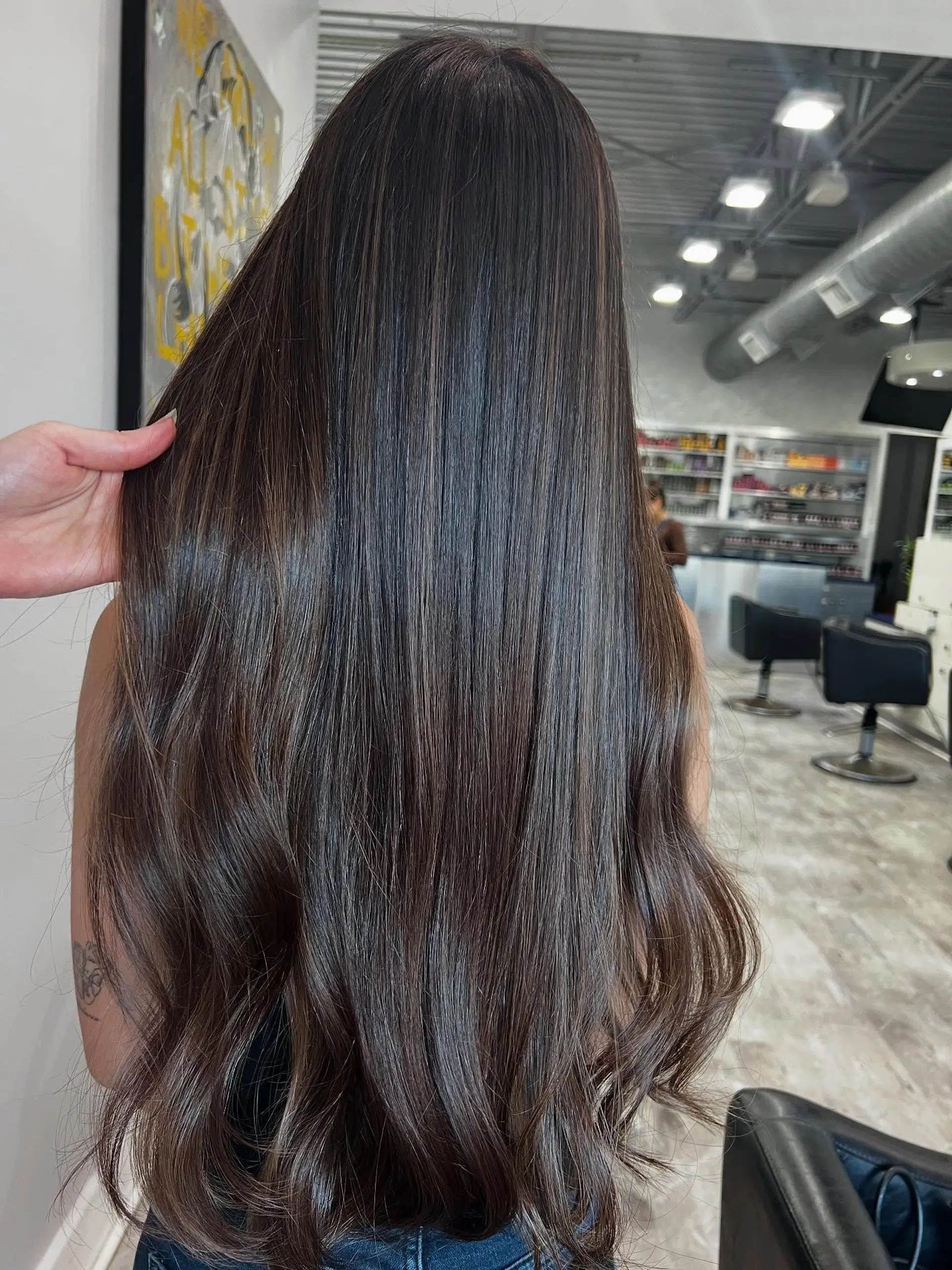 Very long, straight chocolate brunette hair with subtle balayage highlights and soft waves at the ends. 1