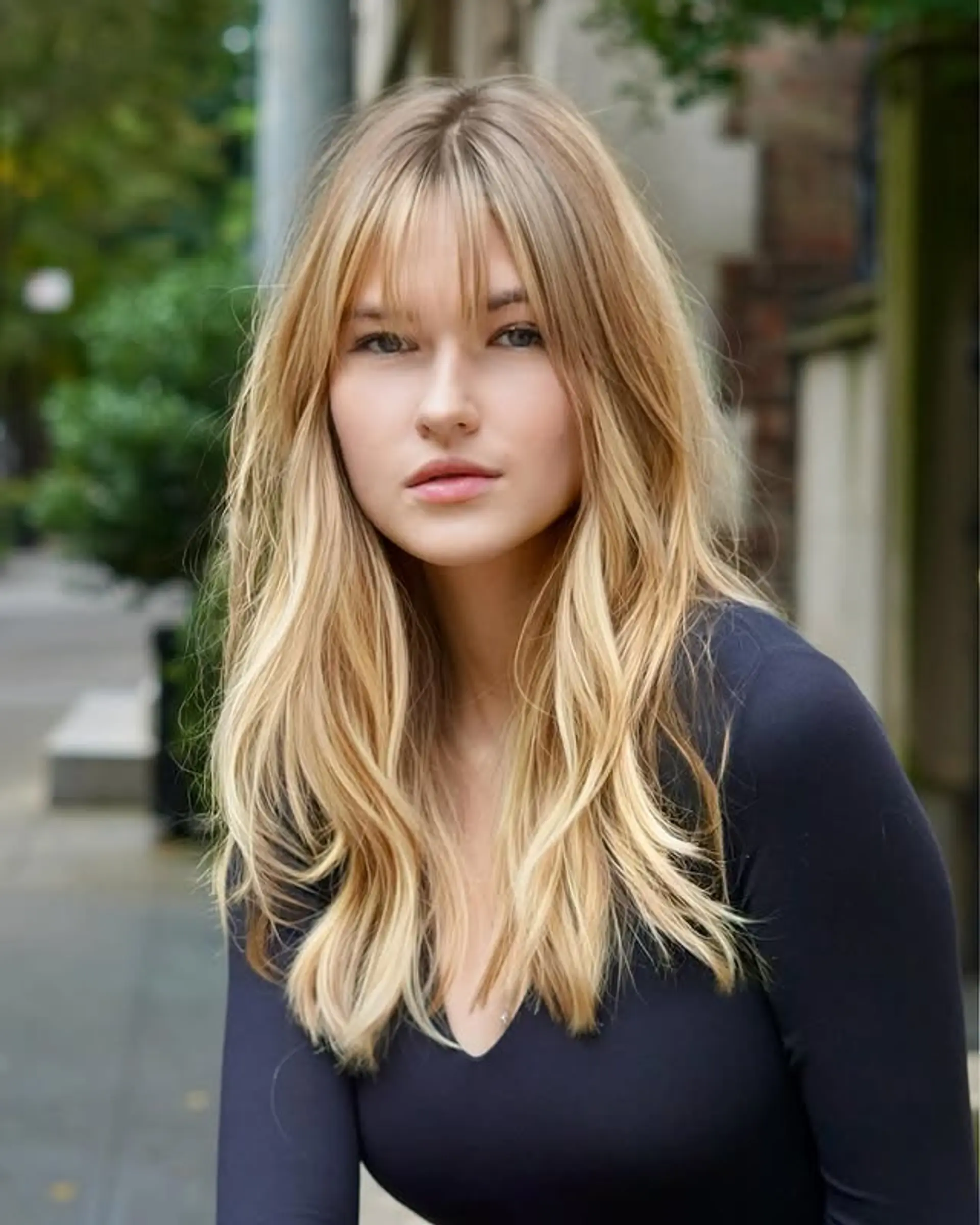 Long wavy hairstyle with curtain bangs and long layered details. 1