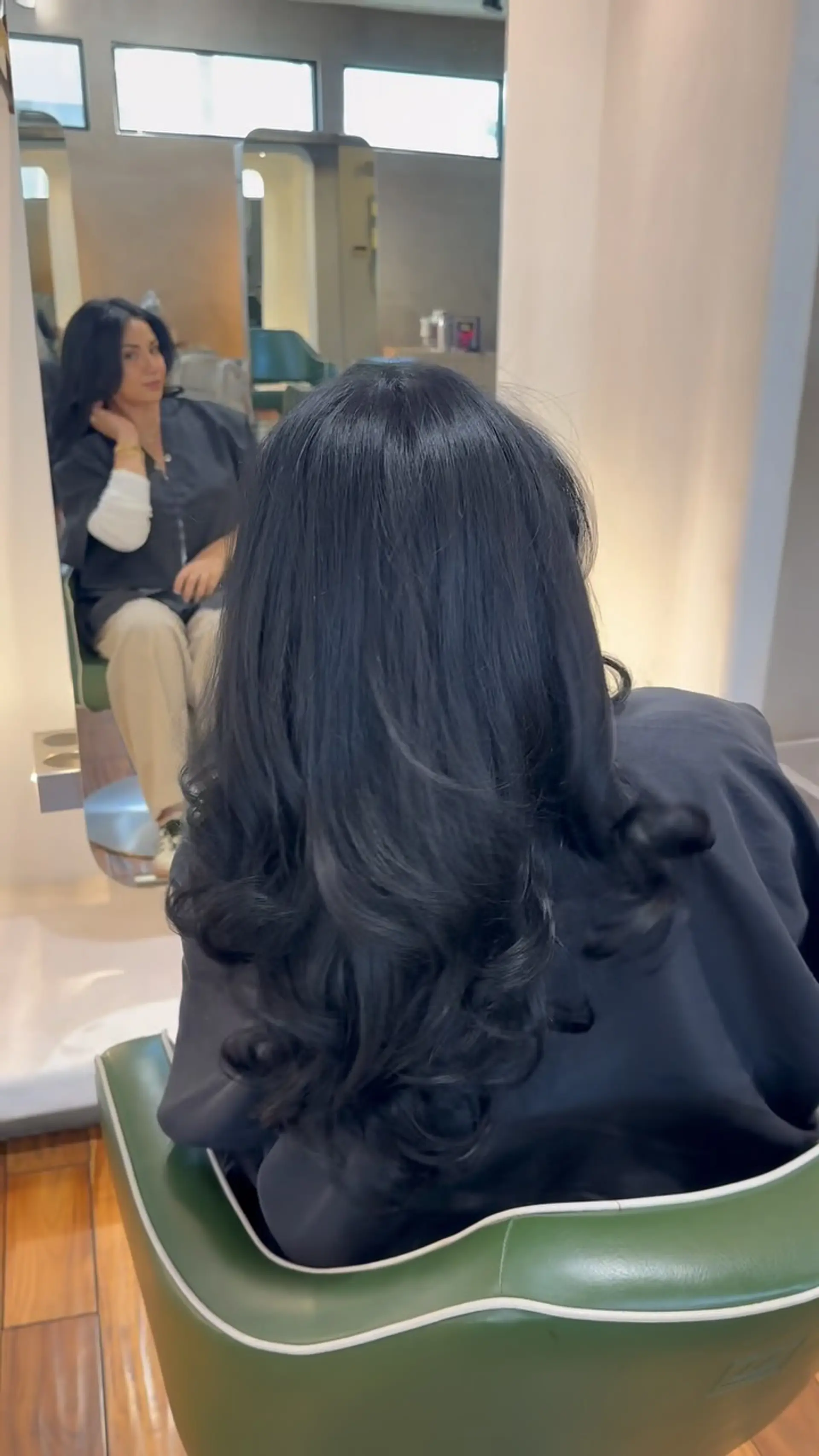 Long, glossy jet-black hair styled in a smooth, voluminous blowout with bouncy curls at the ends. 1