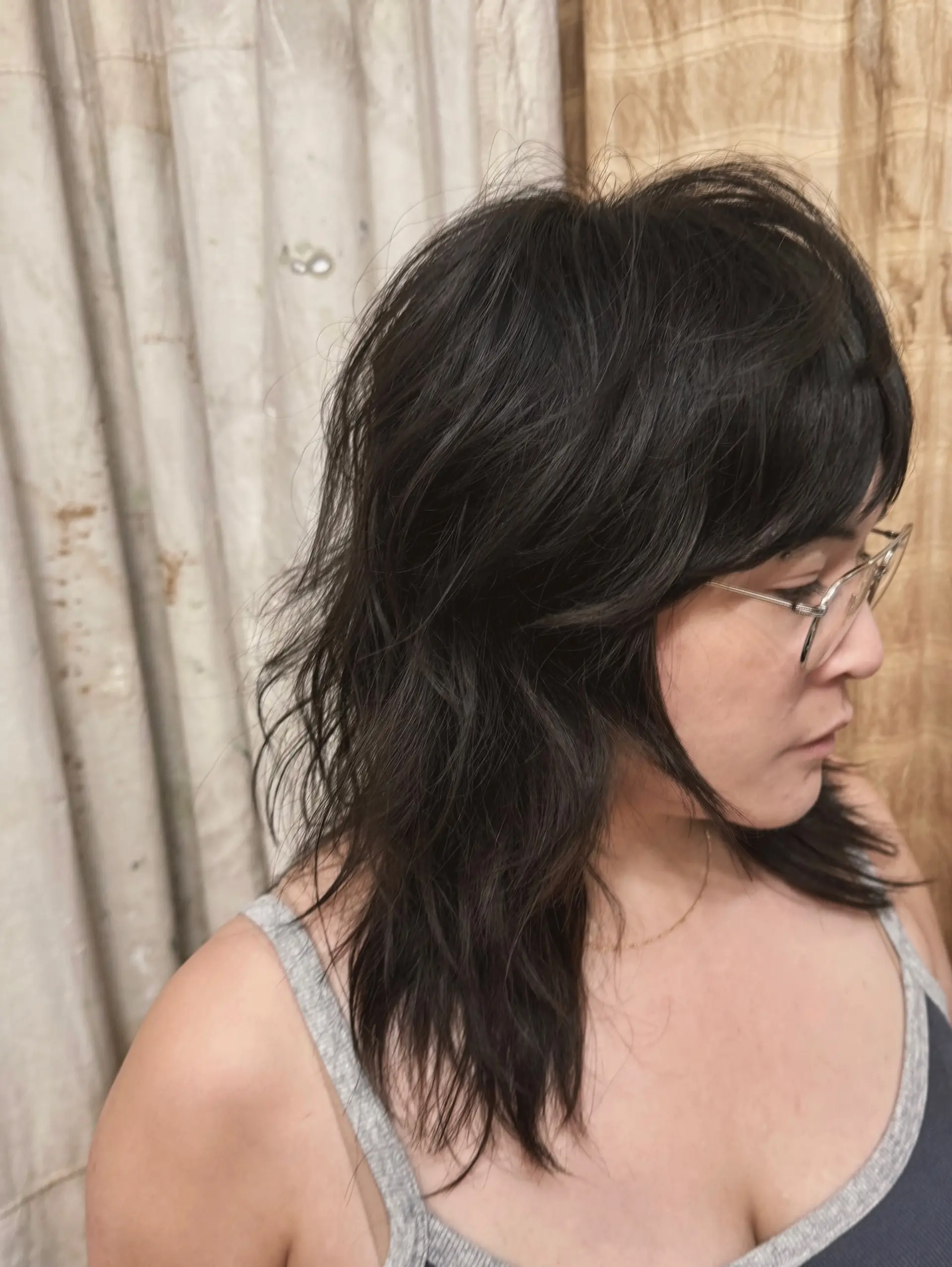A modern shag haircut with textured layers and wispy bangs. 2