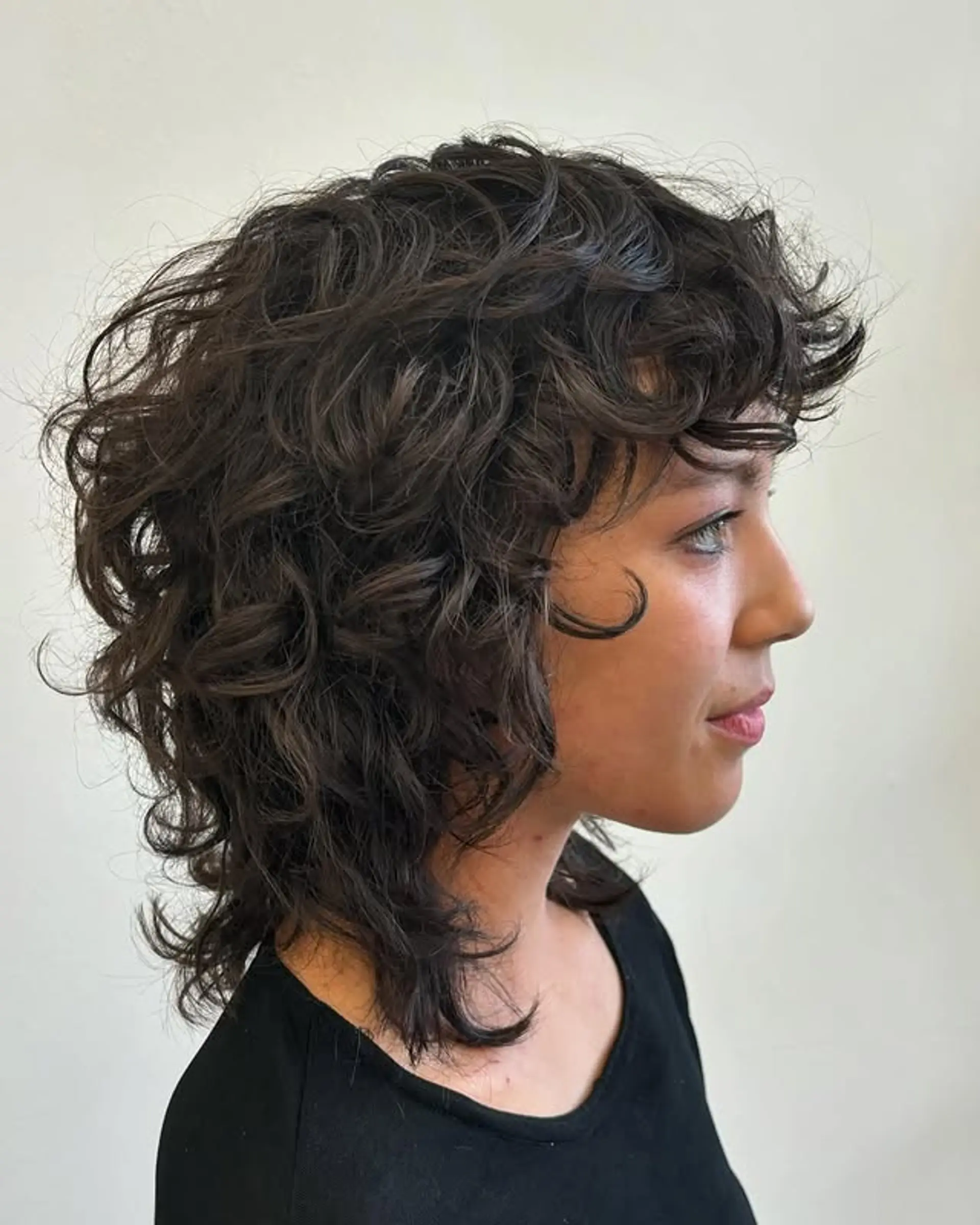 A curly shag with layers and bangs. 1