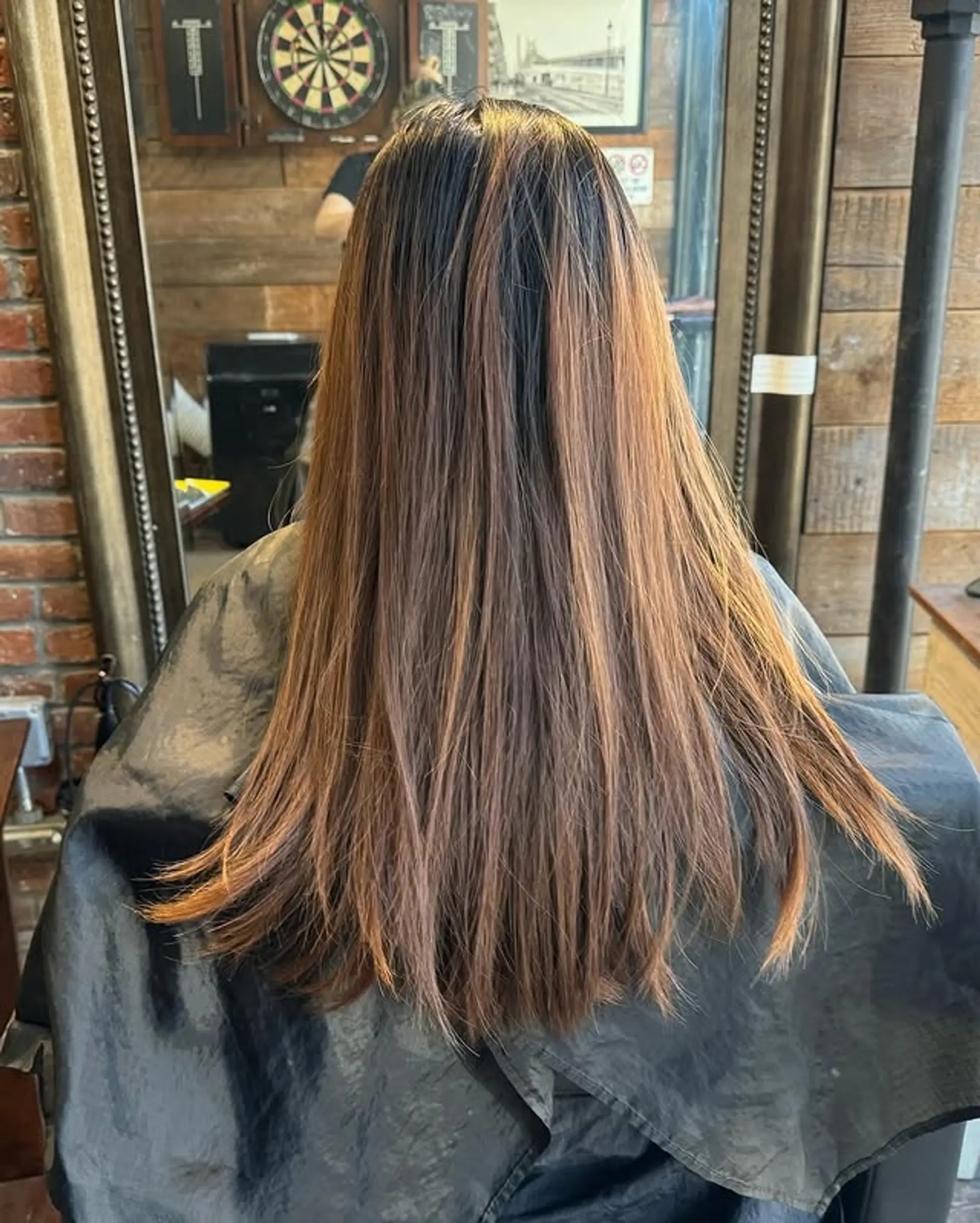Long, straight hair with subtle layers and bronze balayage. 1
