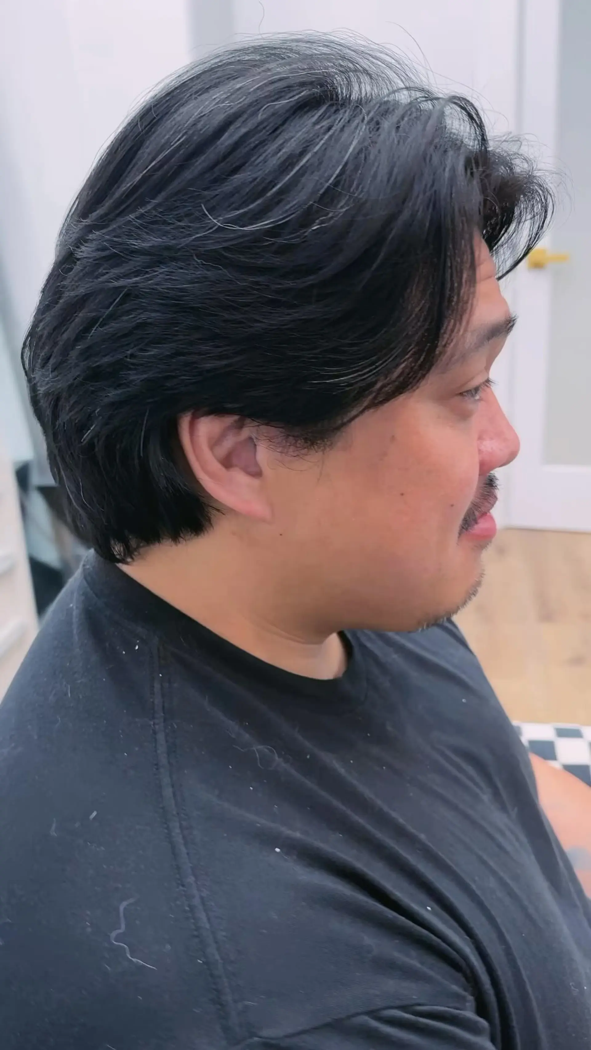 A modern mullet haircut featuring swept-back textured layers on top and sides blending smoothly into the length at the back. 1