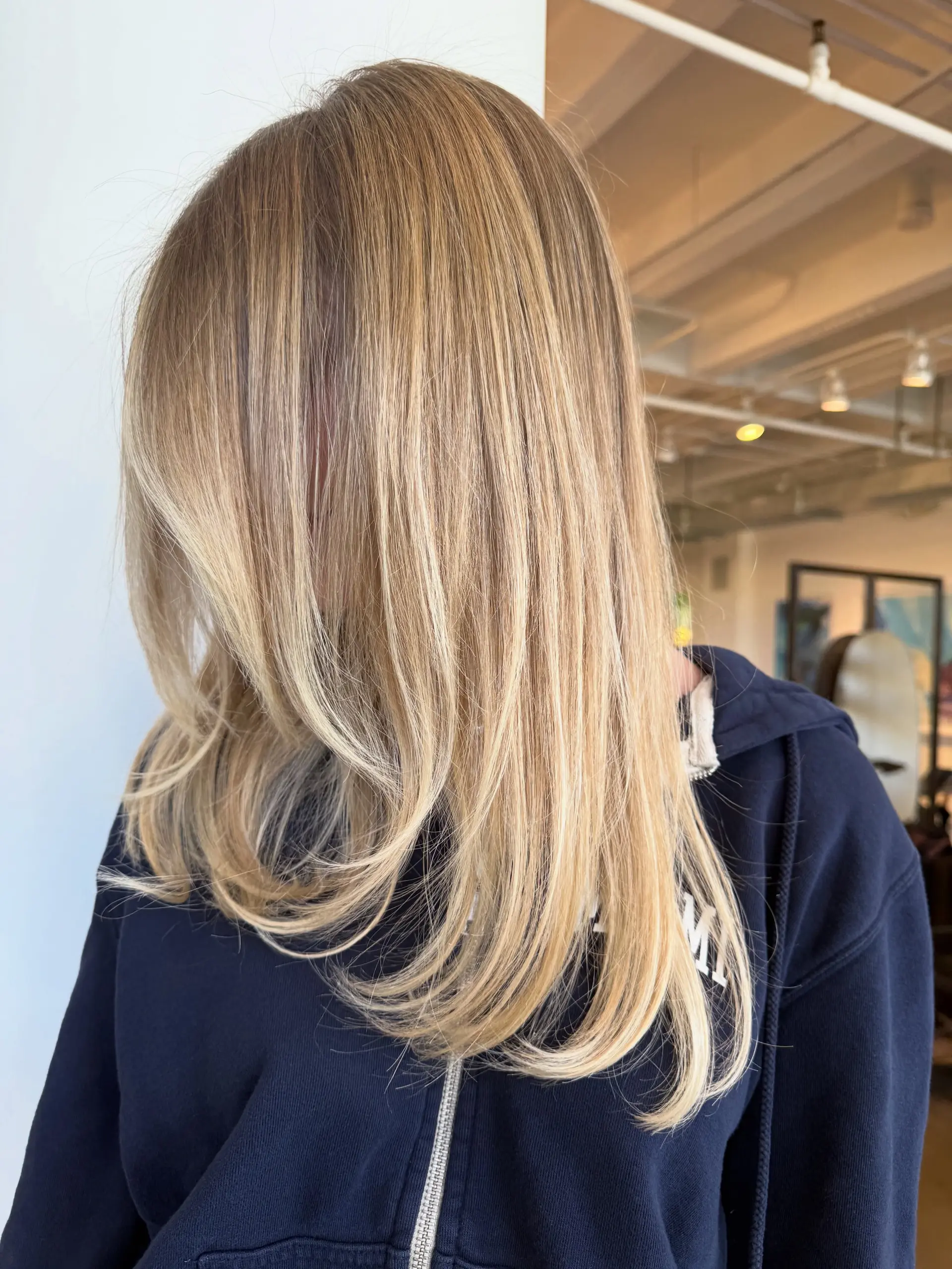 Straight, smooth long hair featuring a seamless golden blonde balayage with gentle face-framing curve at the ends. 1