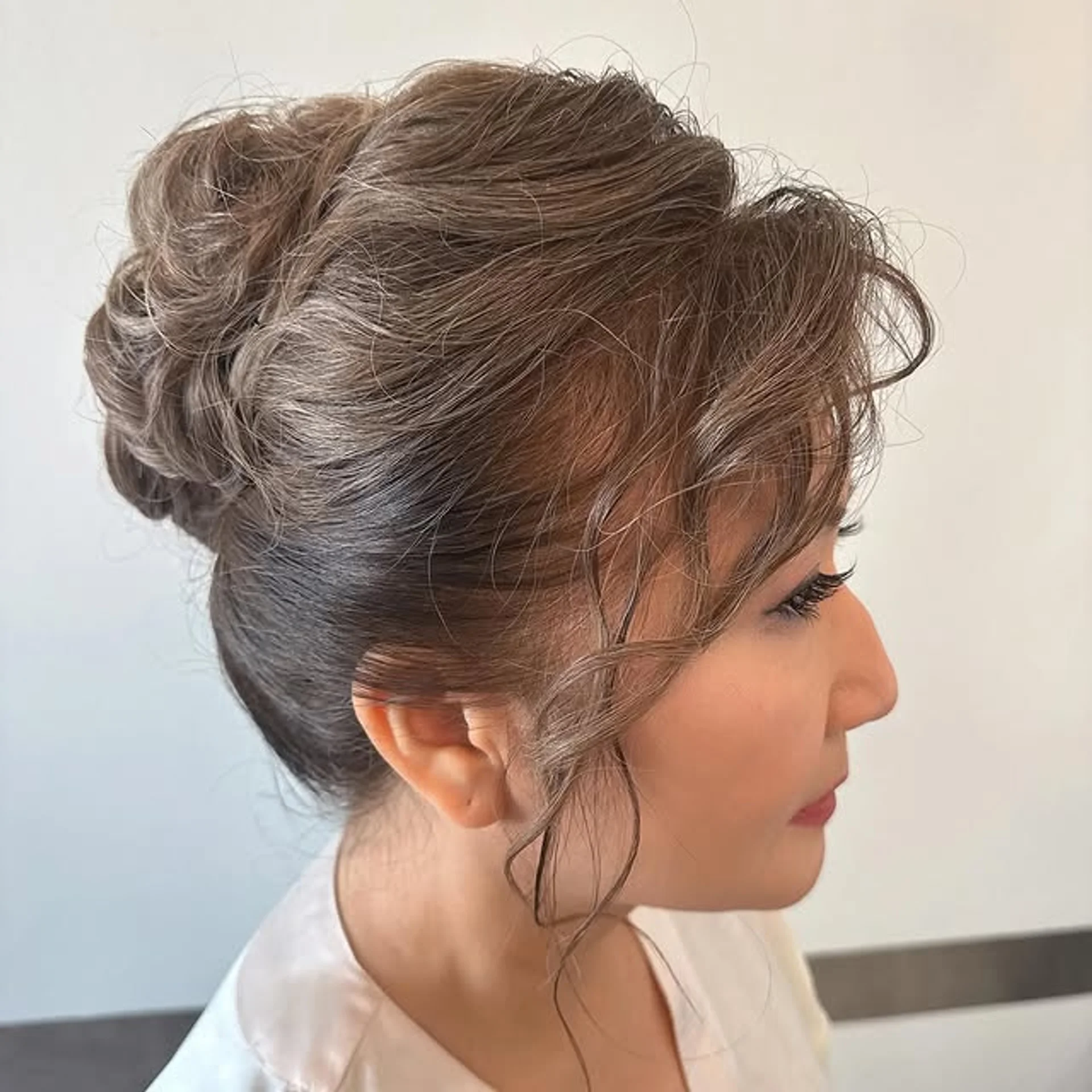 Elegant low bun hairstyle, perfect for a chic holiday party look - Preview 2