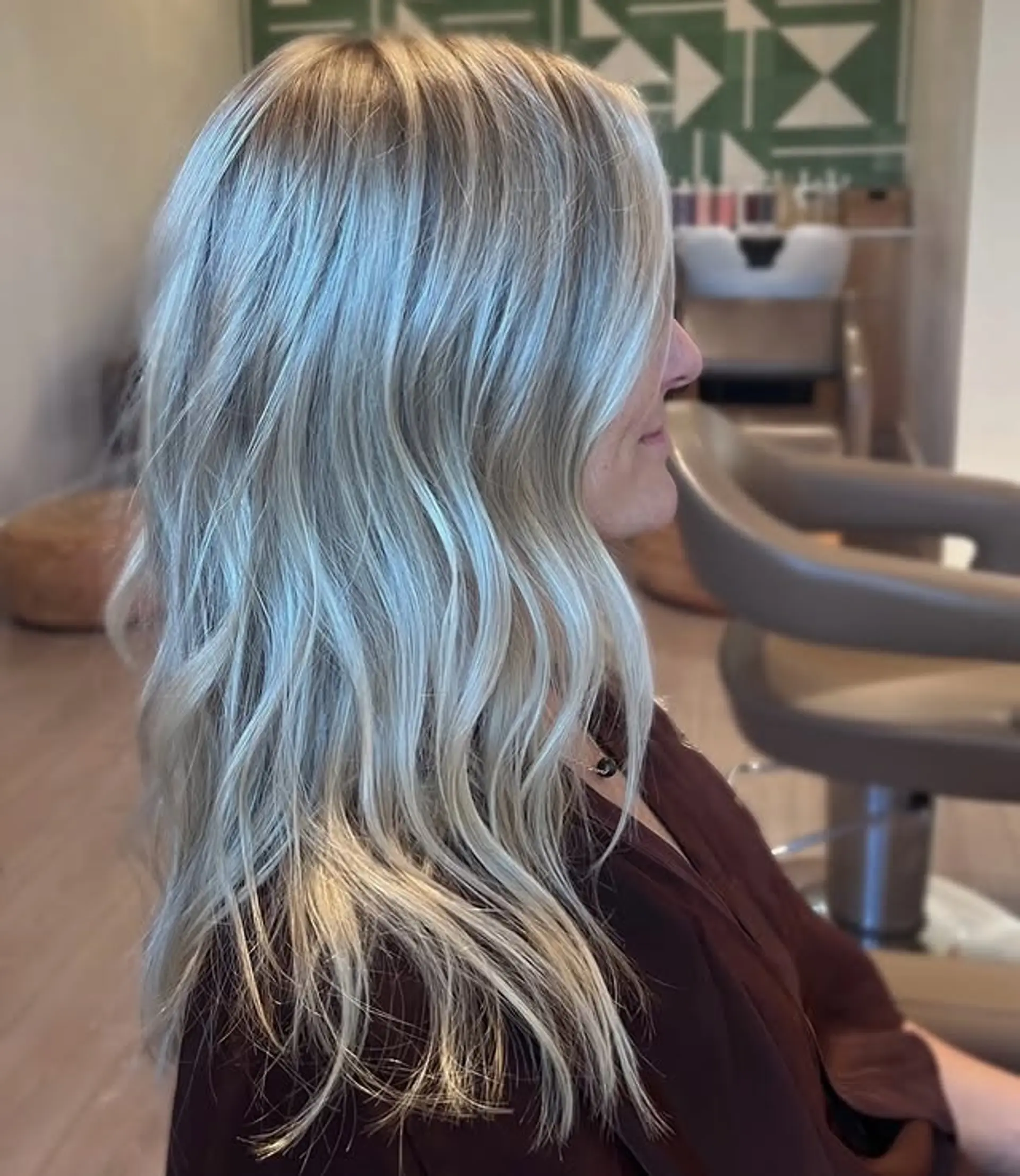 Long wavy hairstyle with ash blonde tones and face-framing layers. 1