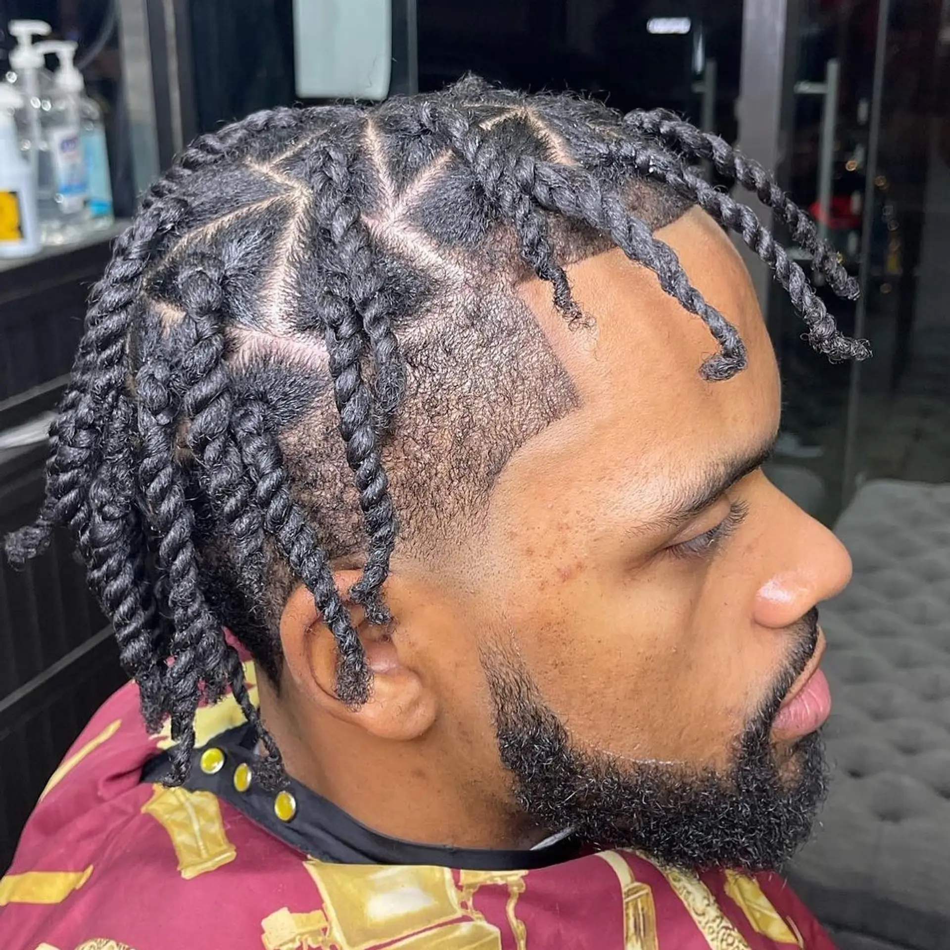 Defined two-strand twists parted neatly on top paired with a sharp skin taper fade and crisp lineup. 1