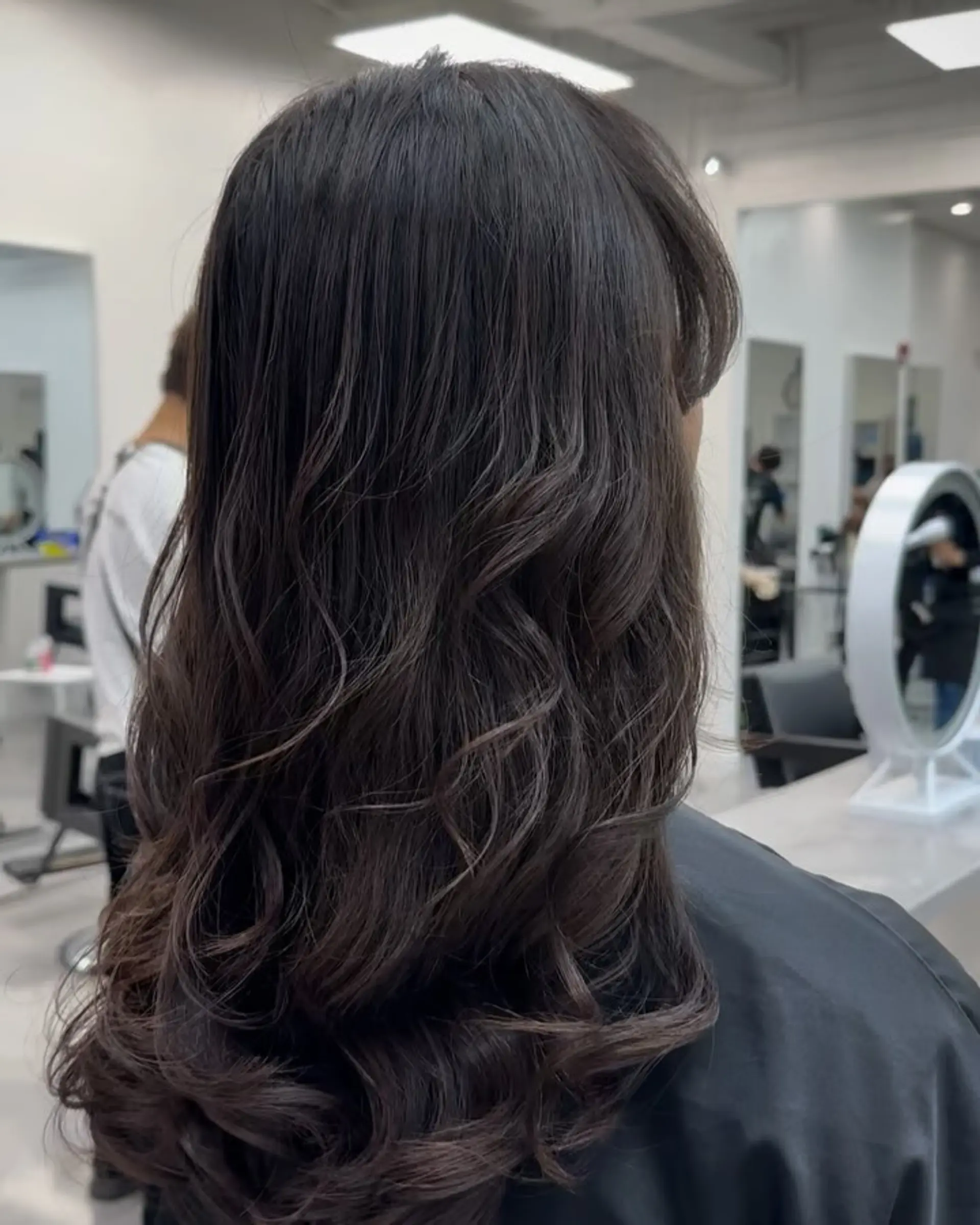 Long dark brown hair featuring layered, soft digital perm waves cascading down the back. 1