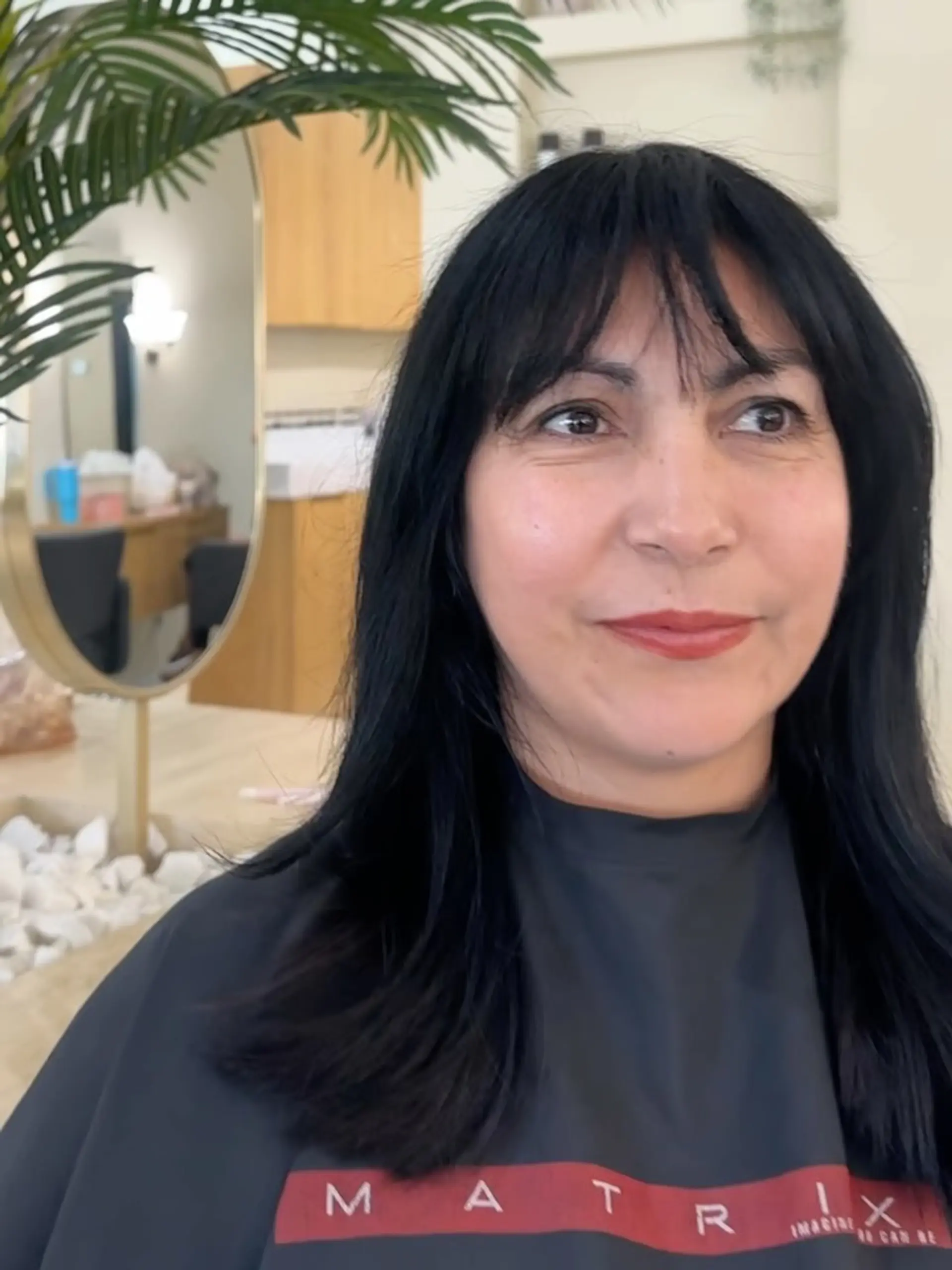 Medium-length black hair cut with soft, seamless layers and light wispy bangs. 1