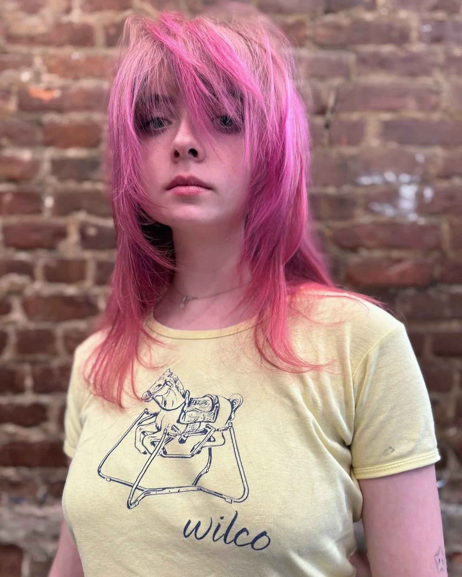 Medium-length textured pink shag cut featuring heavy face-framing layers and long, wispy fringe. 1