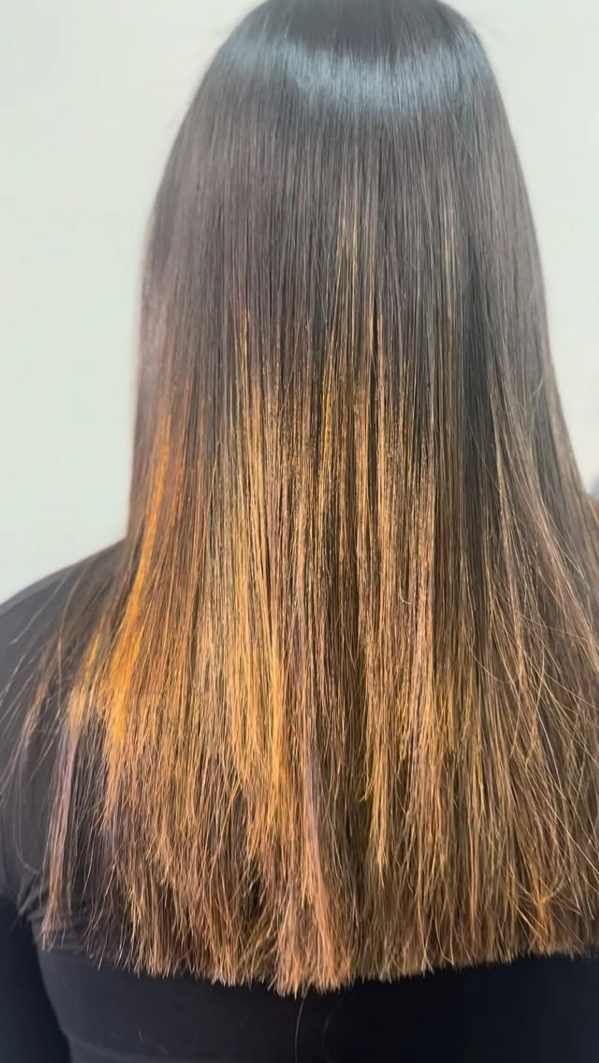 Sleek and glossy straight long hair featuring a dark brown base that blends into warm copper and caramel tones. 1