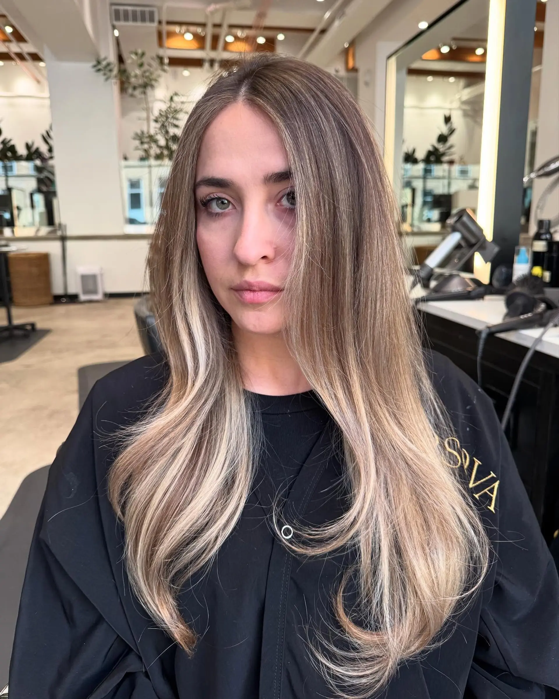 Long, straight hair with a dimensional blonde balayage and subtle waves. 1
