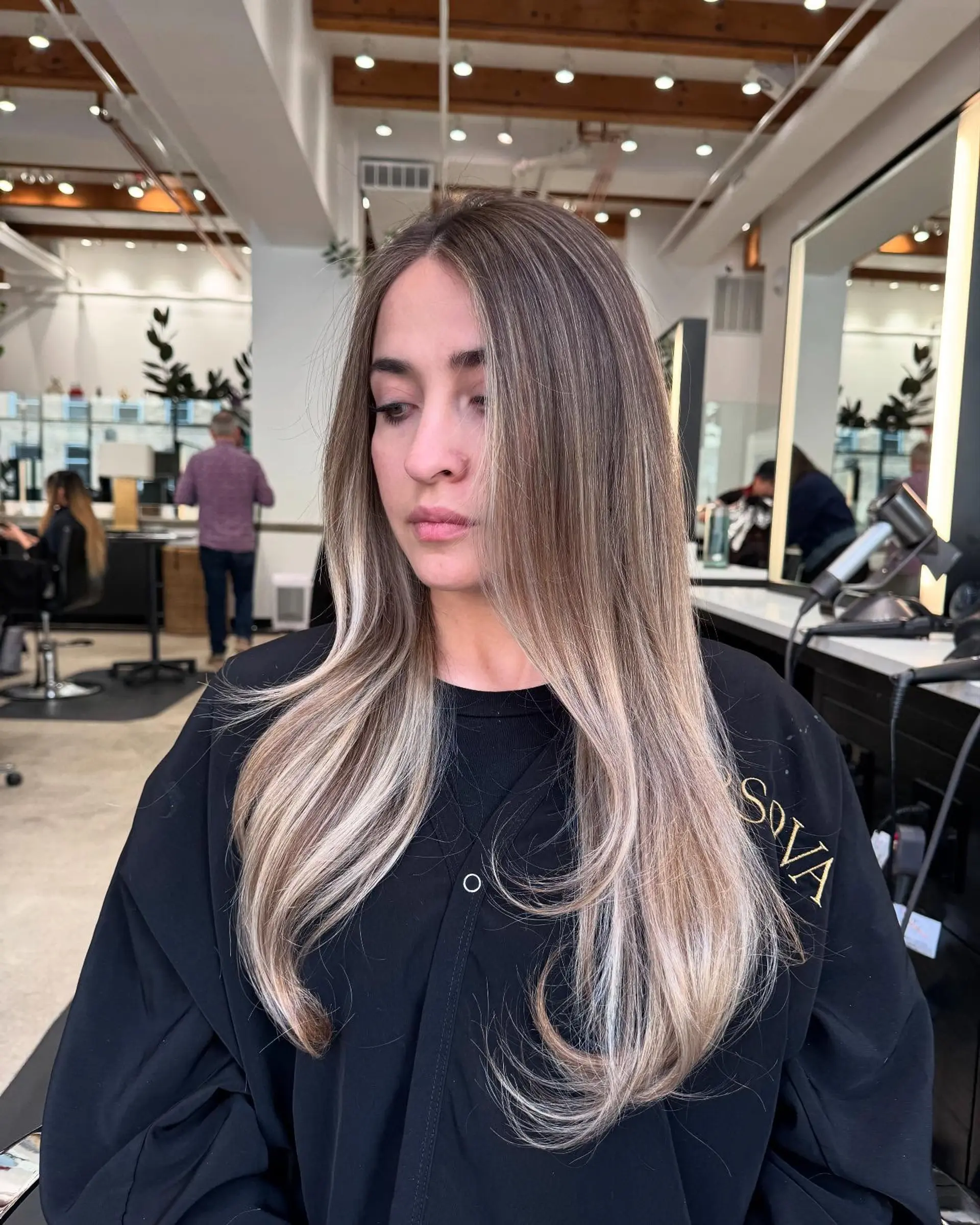 Long, straight hair with a dimensional blonde balayage and subtle waves. 2
