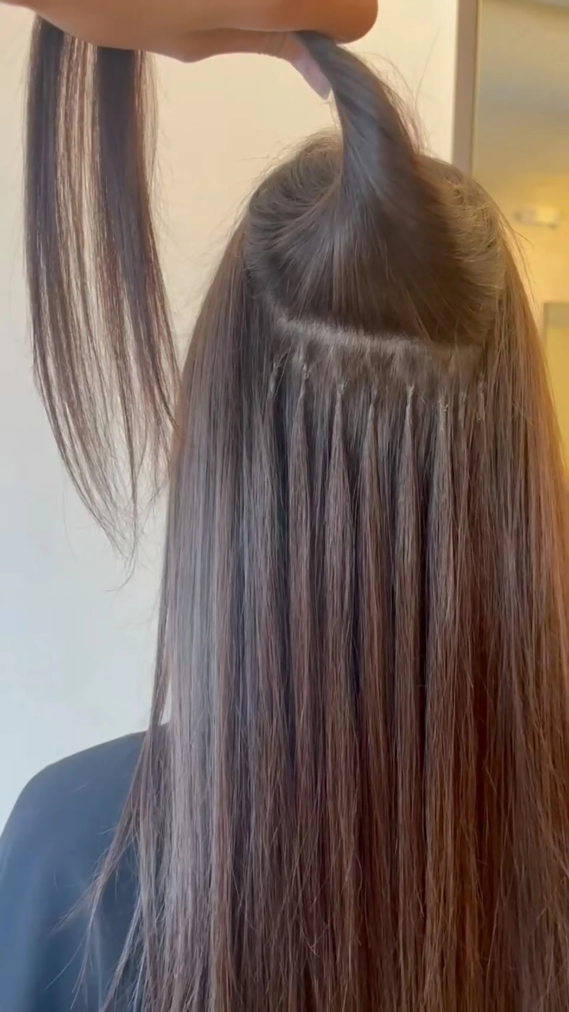 Straight brunette hair showcasing seamless K-tip fusion extensions installed for natural fullness and volume. 1