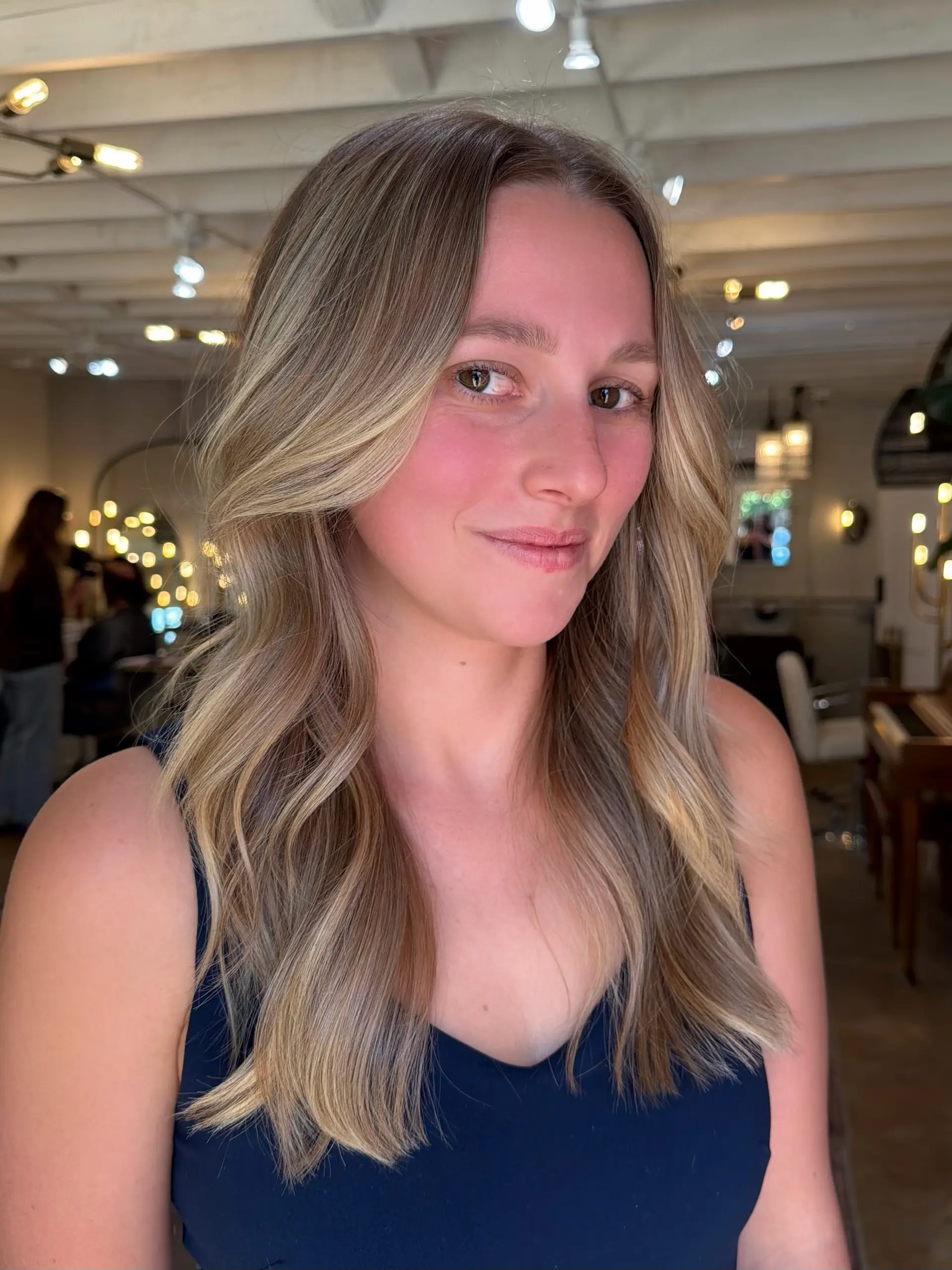 Long layered haircut featuring face-framing curtain layers and smooth, soft waves. 1