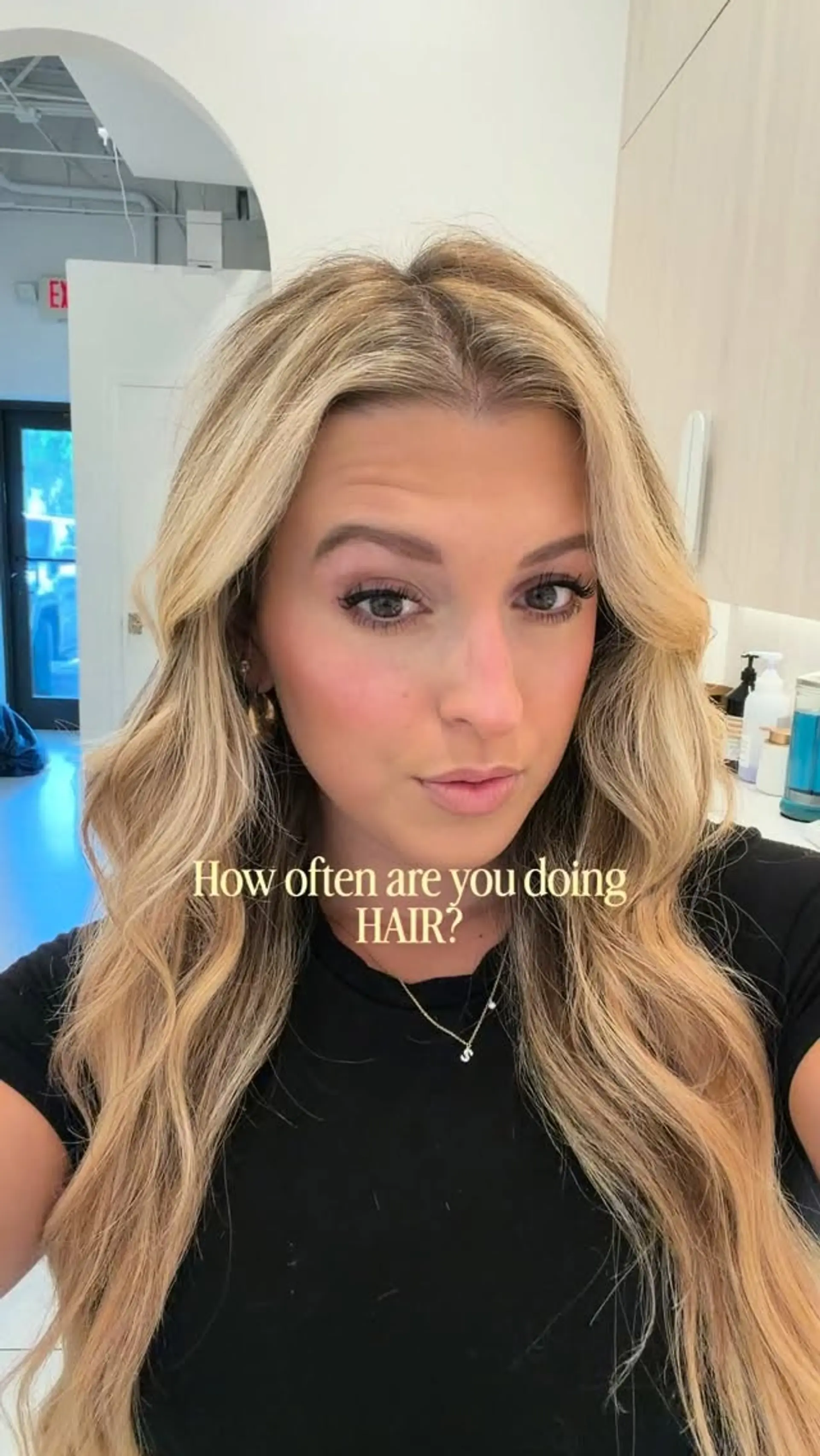 Long, flowing blonde hair styled with soft, loose waves parted down the middle. 1