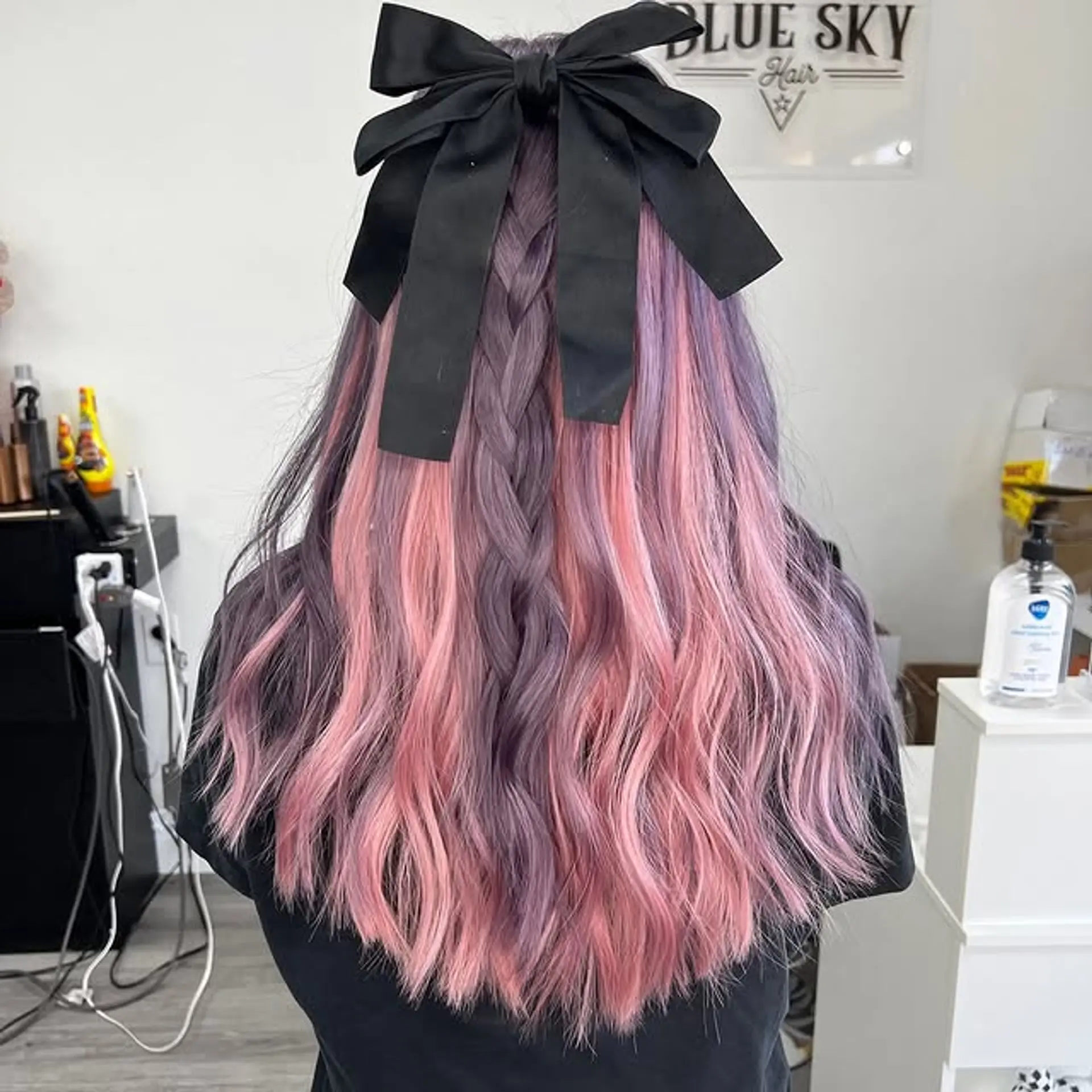 Long wavy hair with a braided style adorned with a ribbon and pastel hair color. 1