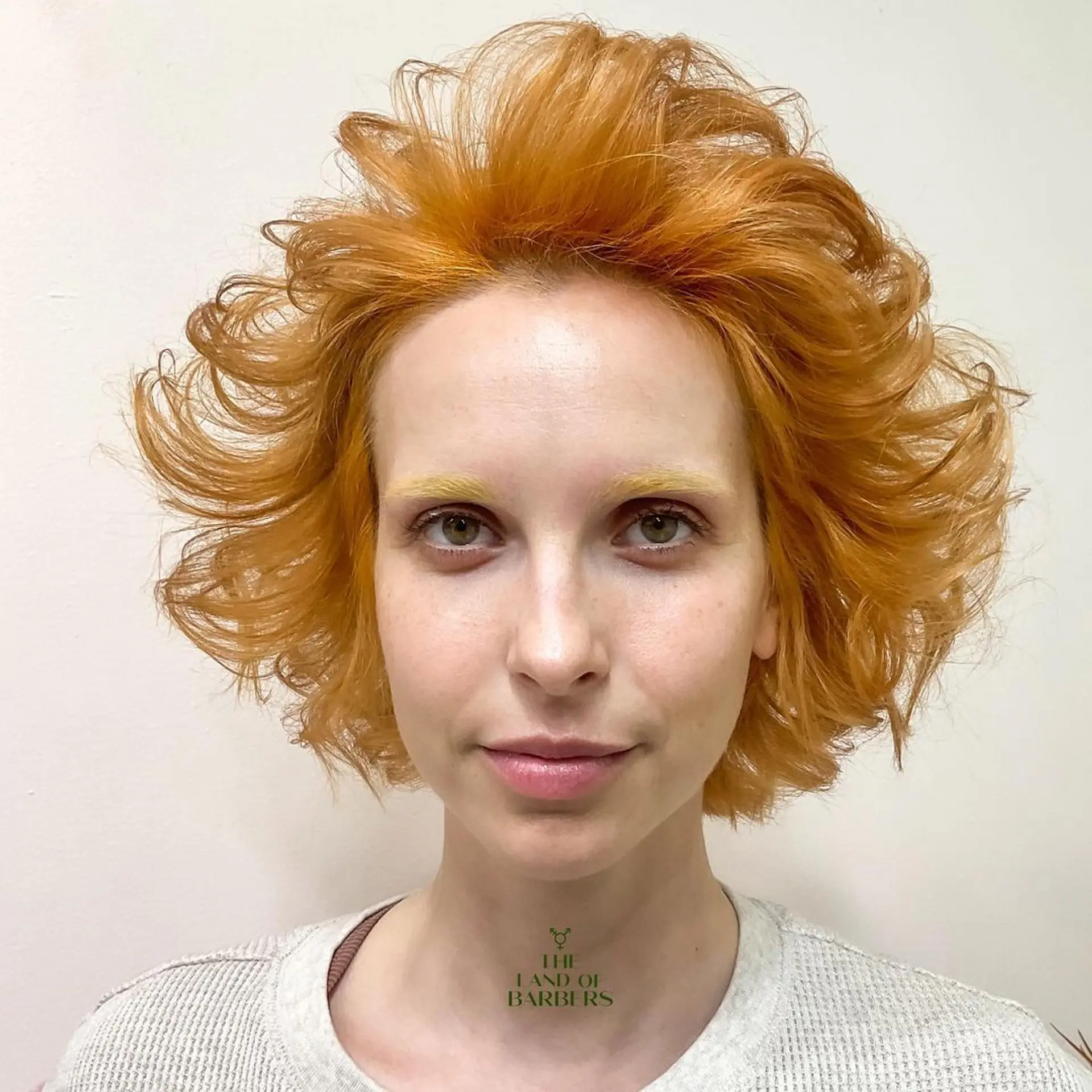 Dynamic, voluminous waves with medium-length layers and textured ends in a striking orange color. 1