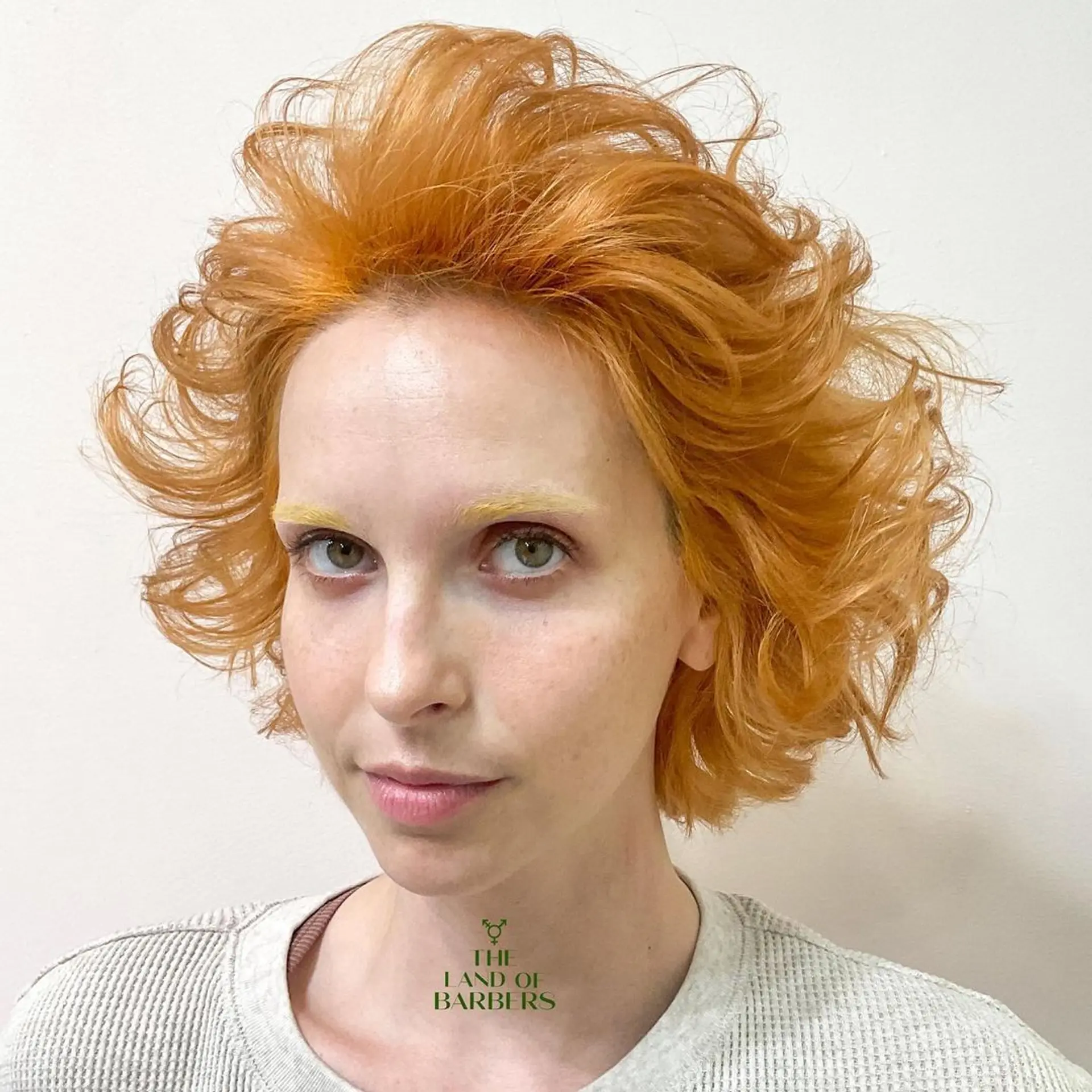 Dynamic, voluminous waves with medium-length layers and textured ends in a striking orange color. 2
