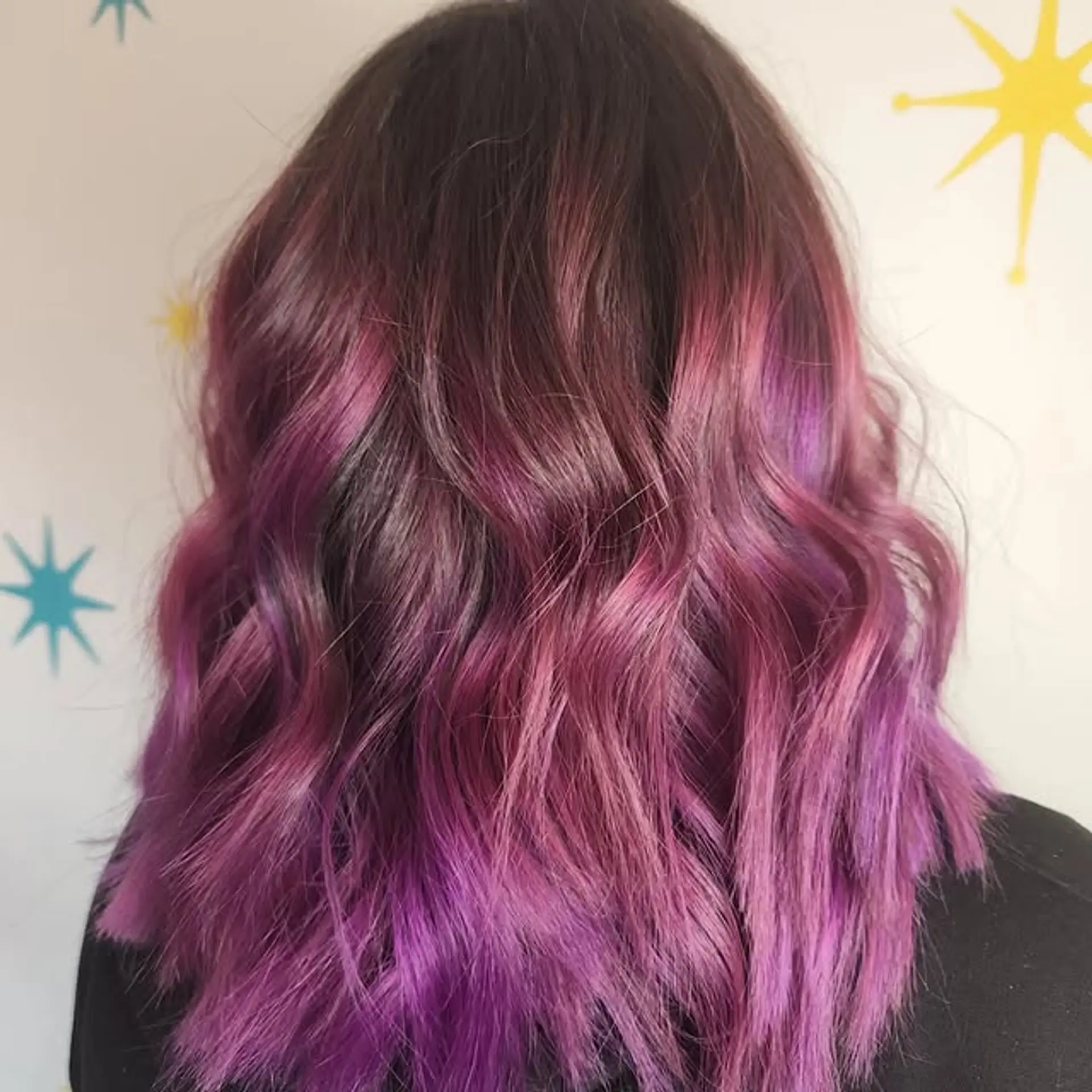 Wavy medium-length hairstyle with a purple and pink ombre. 1