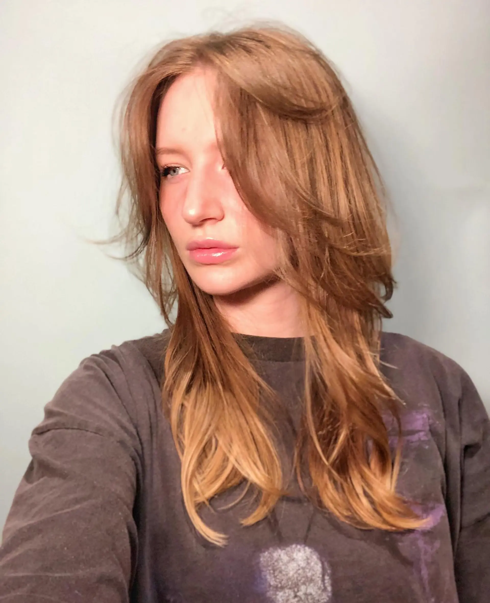 Long layered hairstyle with copper and blonde balayage. 1