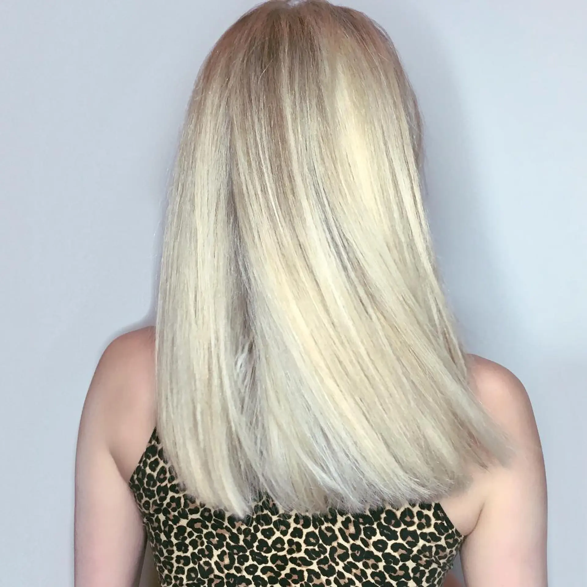 A sleek, icy blonde straight cut with subtle layers. 1