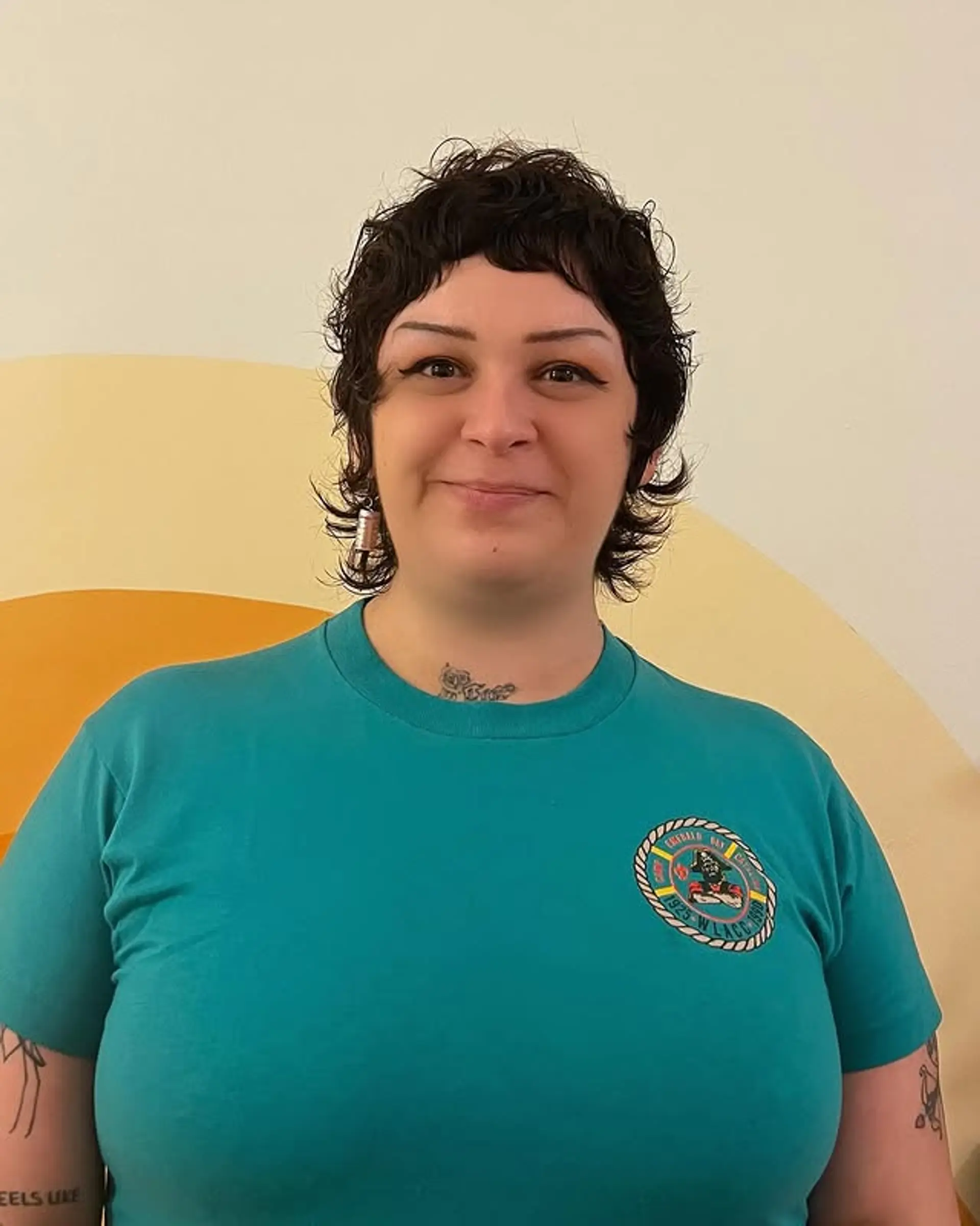 A short, curly shag haircut with choppy layers and short fringe bangs. 1