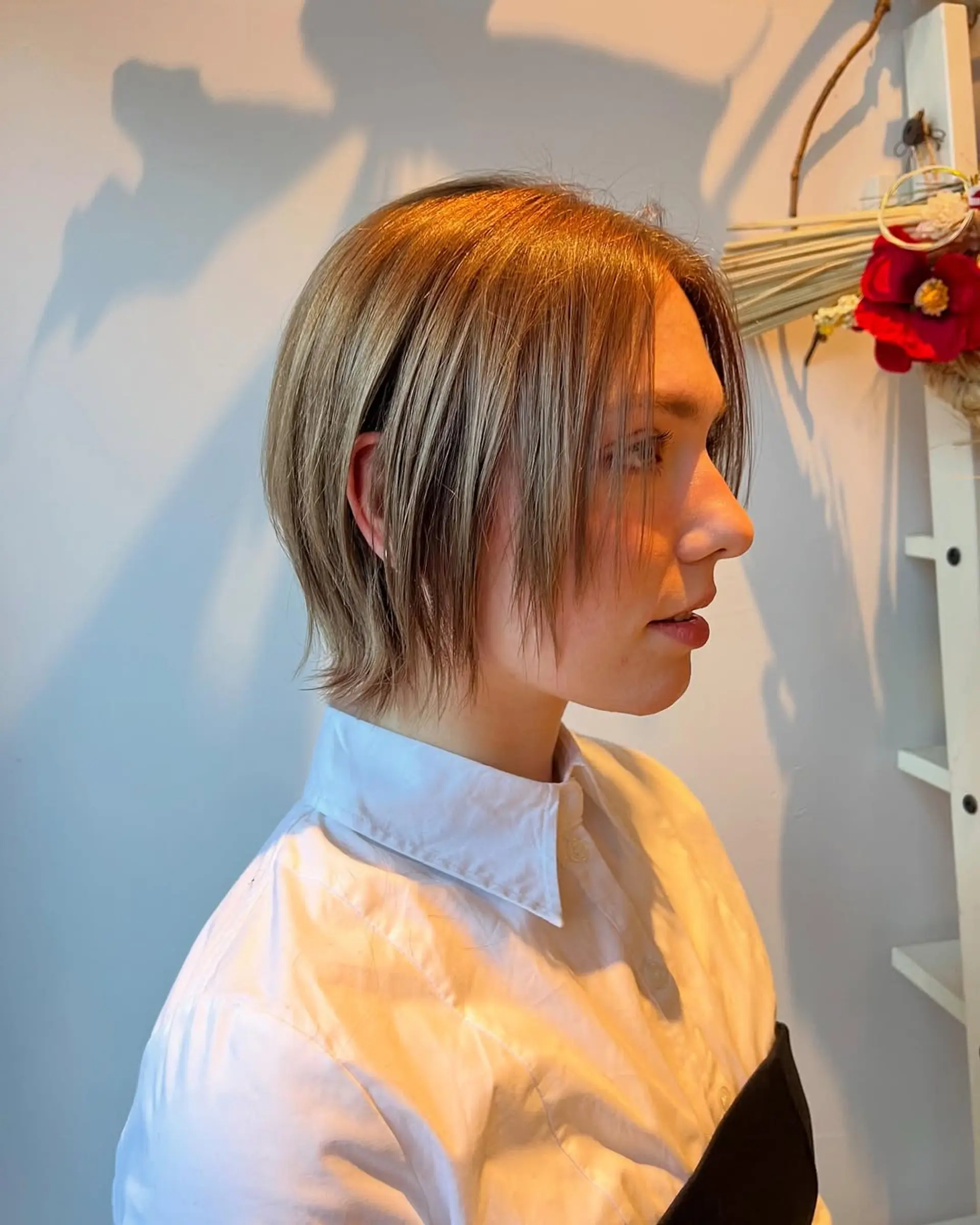 A short, textured bob with subtle layers and ash blonde highlights. 1