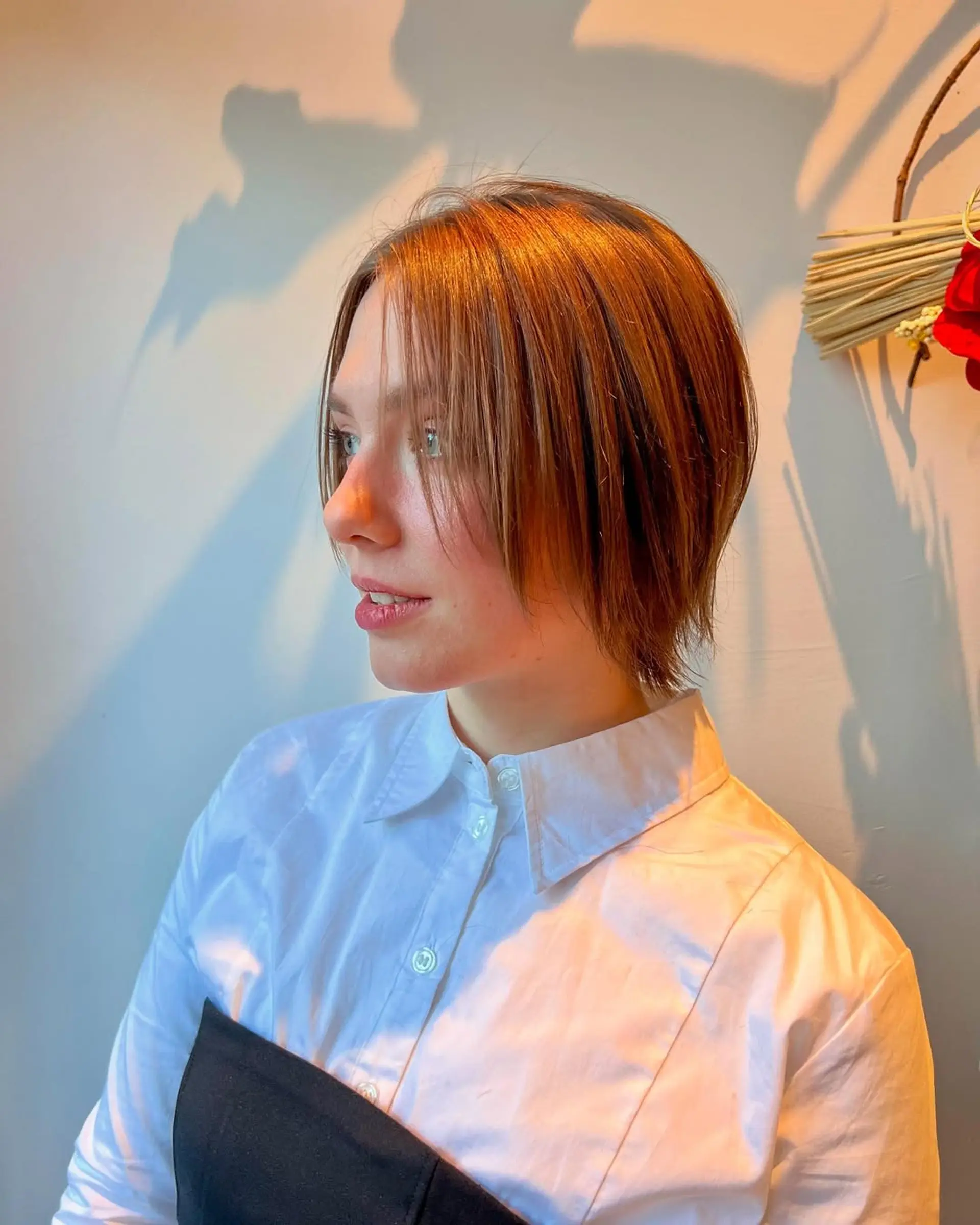 A short, textured bob with subtle layers and ash blonde highlights. 2