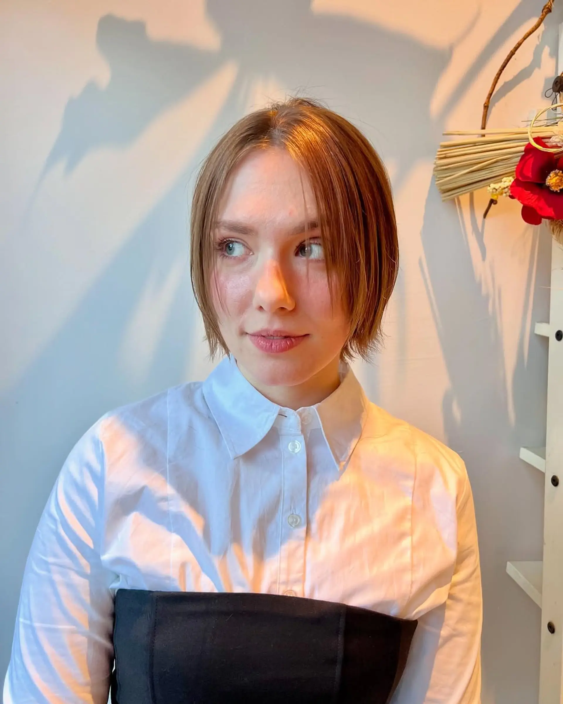 A short, textured bob with subtle layers and ash blonde highlights. 3